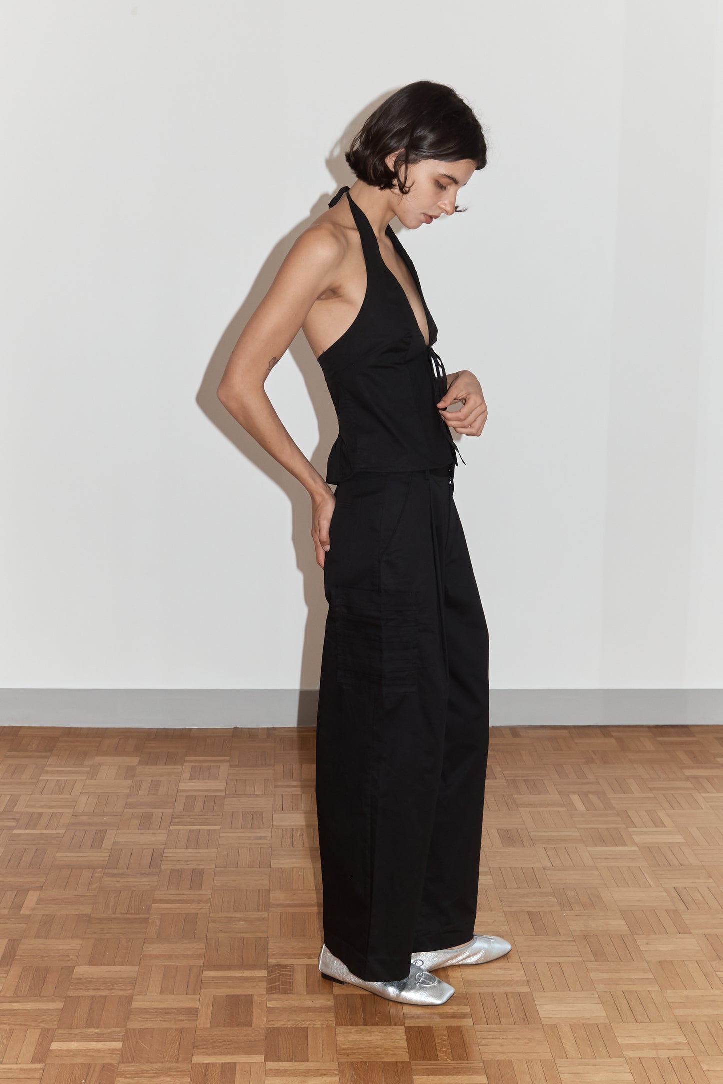 female model wears the open halter top top by Deiji Studios in black
top features open front with centre bust tie, halterneck tie and v neckline, bust seams for subtle shaping and shirred back
made from 100% GOTS certified organic cotton poplin
paired with a black cotton trouser