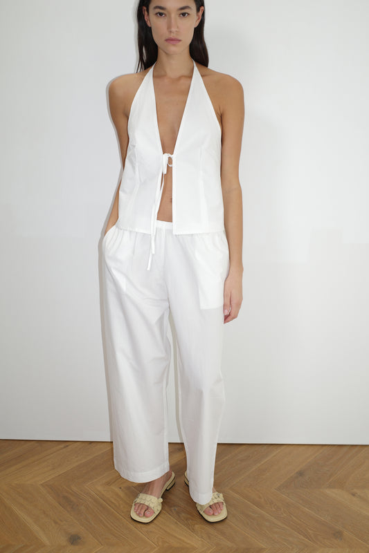 female model wears the open halter top top by Deiji Studios in white
top features open front with centre bust tie, halter neck tie and v neckline, bust seams for subtle shaping and shirred back
made from 100% GOTS certified organic cotton poplin
paired with a white cotton trouser
