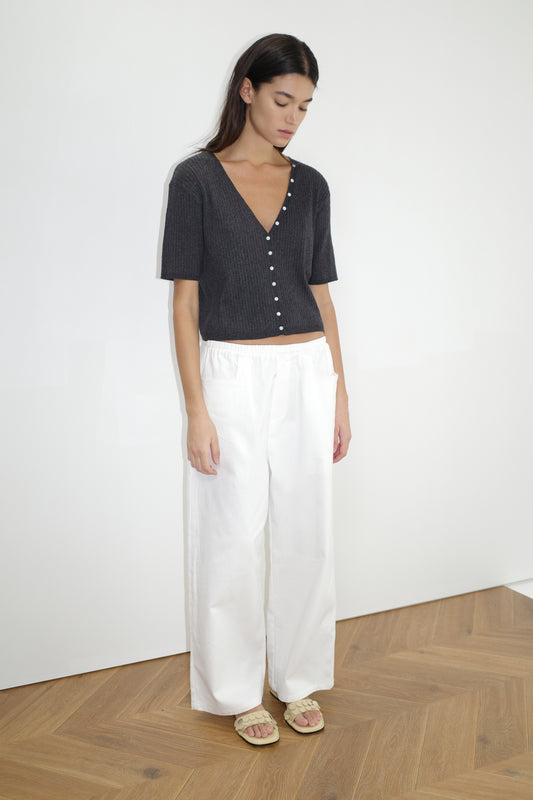 female model wears the one piece tee by Deiji Studios in coal
a fully fashioned ribbed knit features a flattering deep v neckline, mid length sleeve and button front design feature in a relaxed fit
made from 95% BCI cotton and 5% cashmere
paired with a white cotton trouser