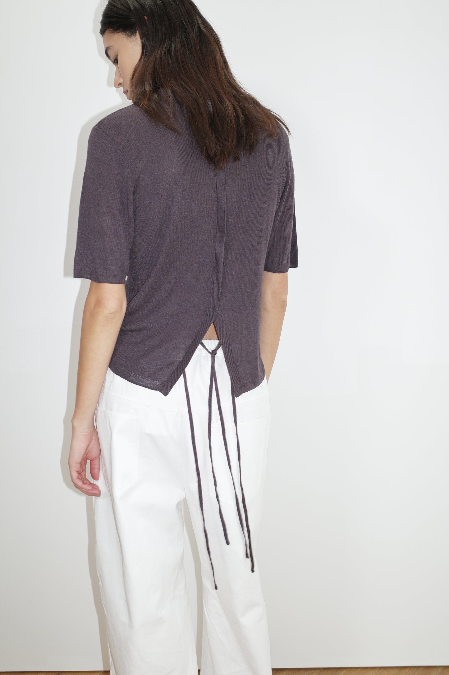 the split back tee by Deiji Studios in eggplant
a fully fashioned, relaxed short-sleeve tee featuring a ribbed texture and a split back detail with flat tie closures
made from 90% eco-viscose and 10% linen
paired with a white cotton trouser