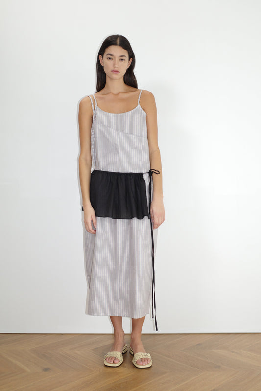female model wears the double layer dress by Deiji Studios in seas stripe worn here with the peplum belt black
a mid-length dress featuring adjustable underlayer straps with sliders for a customised fit and a tied overlayer strap detail at the shoulder.
made from 100% organic cotton poplin
