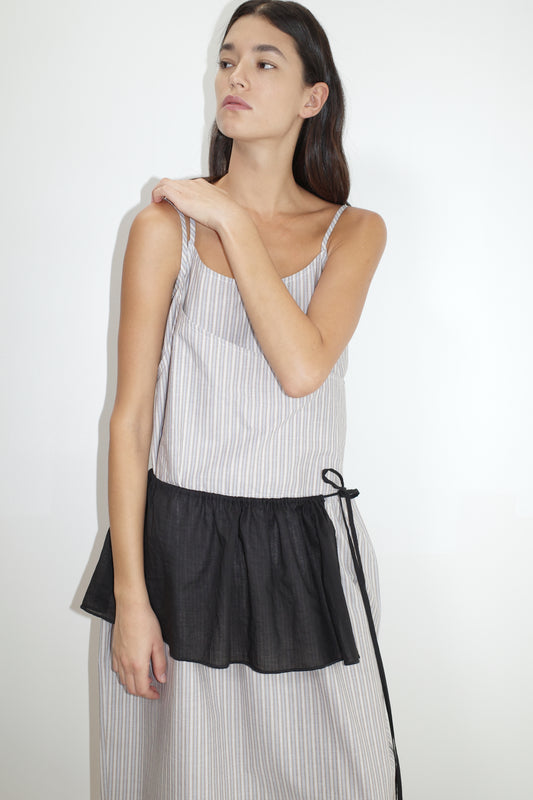 female model wears the double layer dress by Deiji Studios in seas stripe worn here with the peplum belt black
a mid-length dress featuring adjustable underlayer straps with sliders for a customised fit and a tied overlayer strap detail at the shoulder.
made from 100% organic cotton poplin