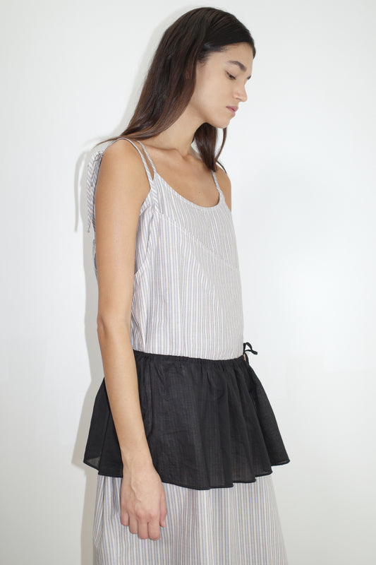 female model wears the double layer dress by Deiji Studios in seas stripe worn here with the peplum belt black
a mid-length dress featuring adjustable underlayer straps with sliders for a customised fit and a tied overlayer strap detail at the shoulder.
made from 100% organic cotton poplin