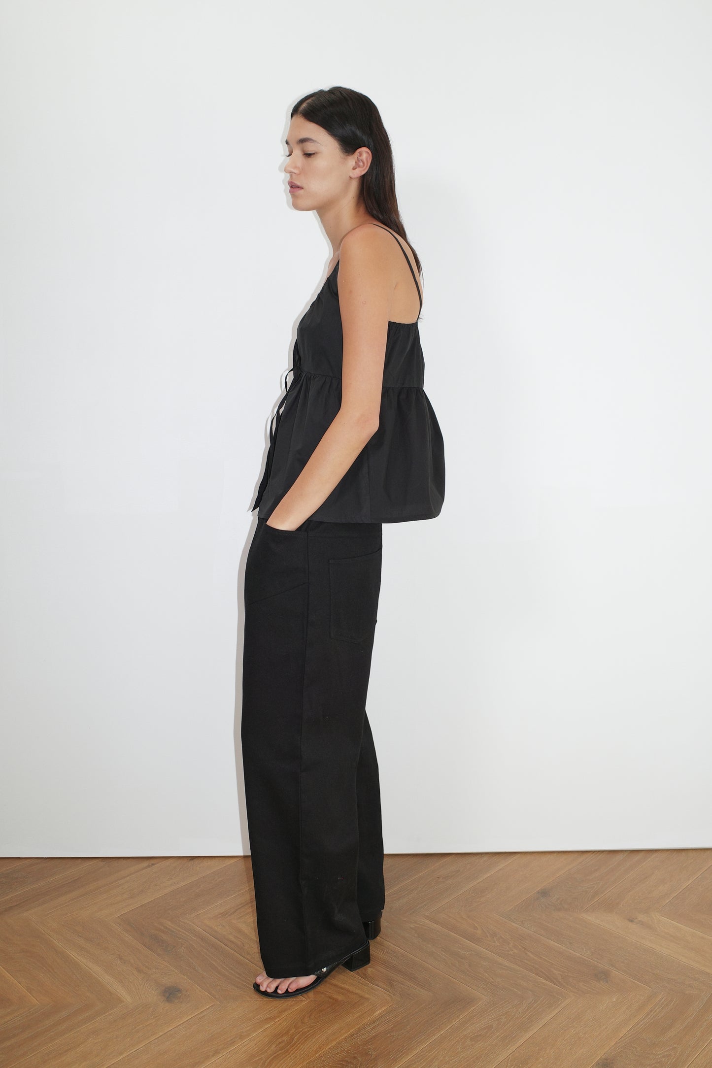 the double tie top by Deiji Studios in black
reversible relaxed top featuring flattering curved neckline and two tie detail at front, drawcord casing feature and fine straps.
made from 100% organic cotton poplin
paired with a black cotton trouser