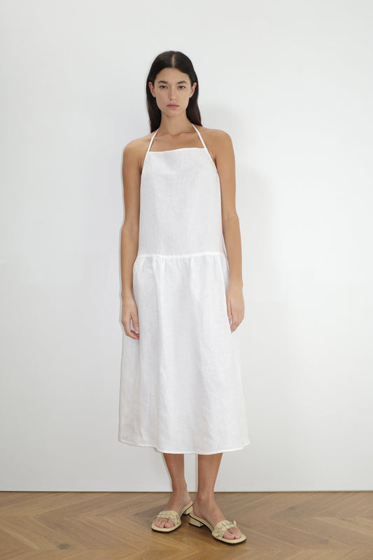 female model wears the gathered halter dress by Deiji Studios in white
a relaxed mid-length dress featuring a drop waist with soft gathered skirt. gathering under the armholes and adjusttable tie straps at back
crafted from 100% OEKO-TEX 100 certified and EU-certified stone-washed french linen, offering a luxurious and breathable feel