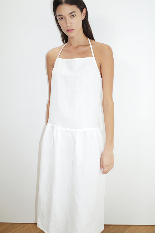 female model wears the gathered halter dress by Deiji Studios in white
a relaxed mid-length dress featuring a drop waist with soft gathered skirt. gathering under the armholes and adjusttable tie straps at back
crafted from 100% OEKO-TEX 100 certified and EU-certified stone-washed french linen, offering a luxurious and breathable feel