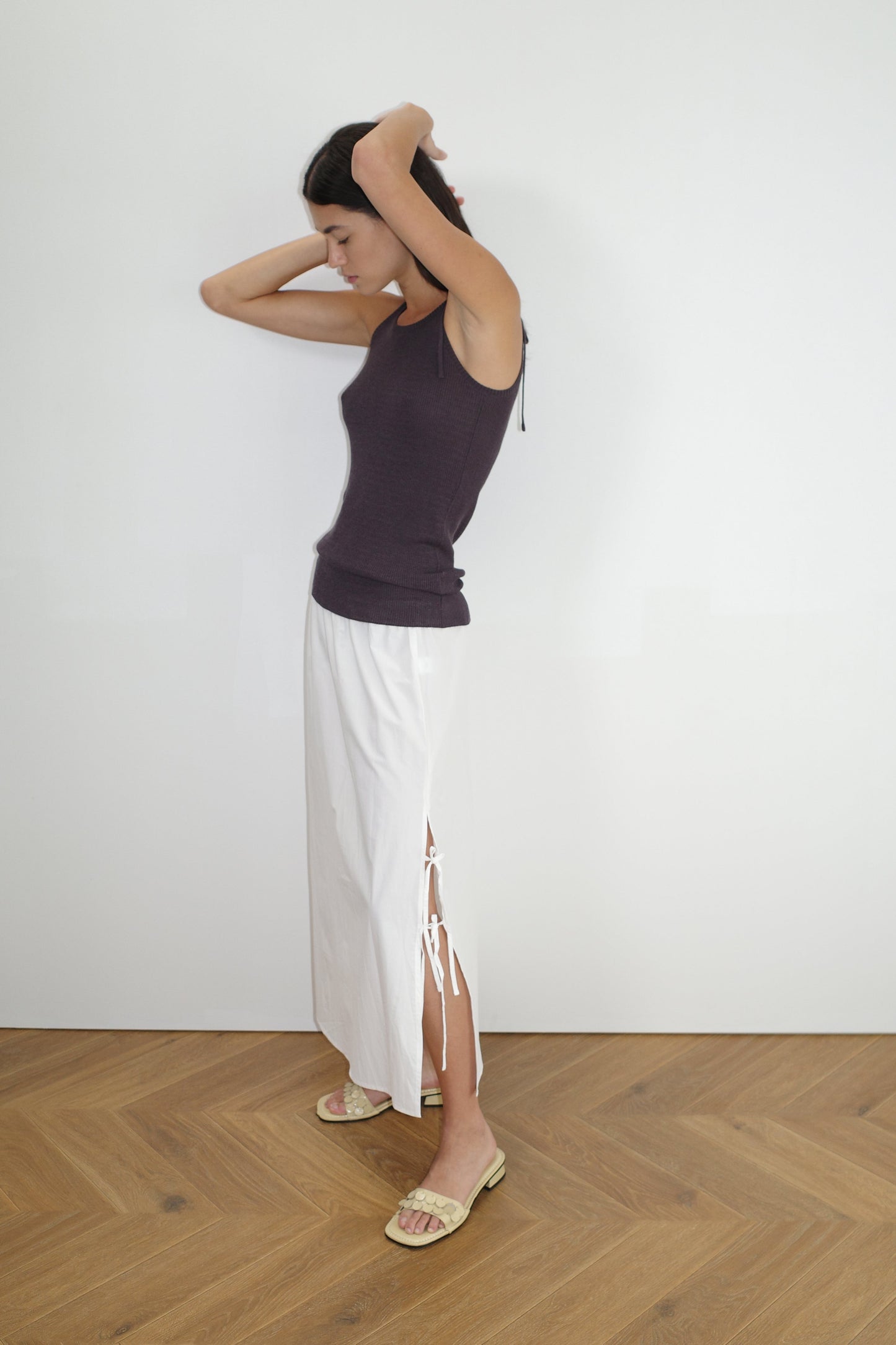 female model wears the split tie skirt by Deiji Studios in white
a mid length, airy skirt designed to sit mid-rise with a soft gathered elastic waist and split side featuring two ties
made from 100% GOTS certified organic cotton poplin
paired with a knit tank in eggplant
