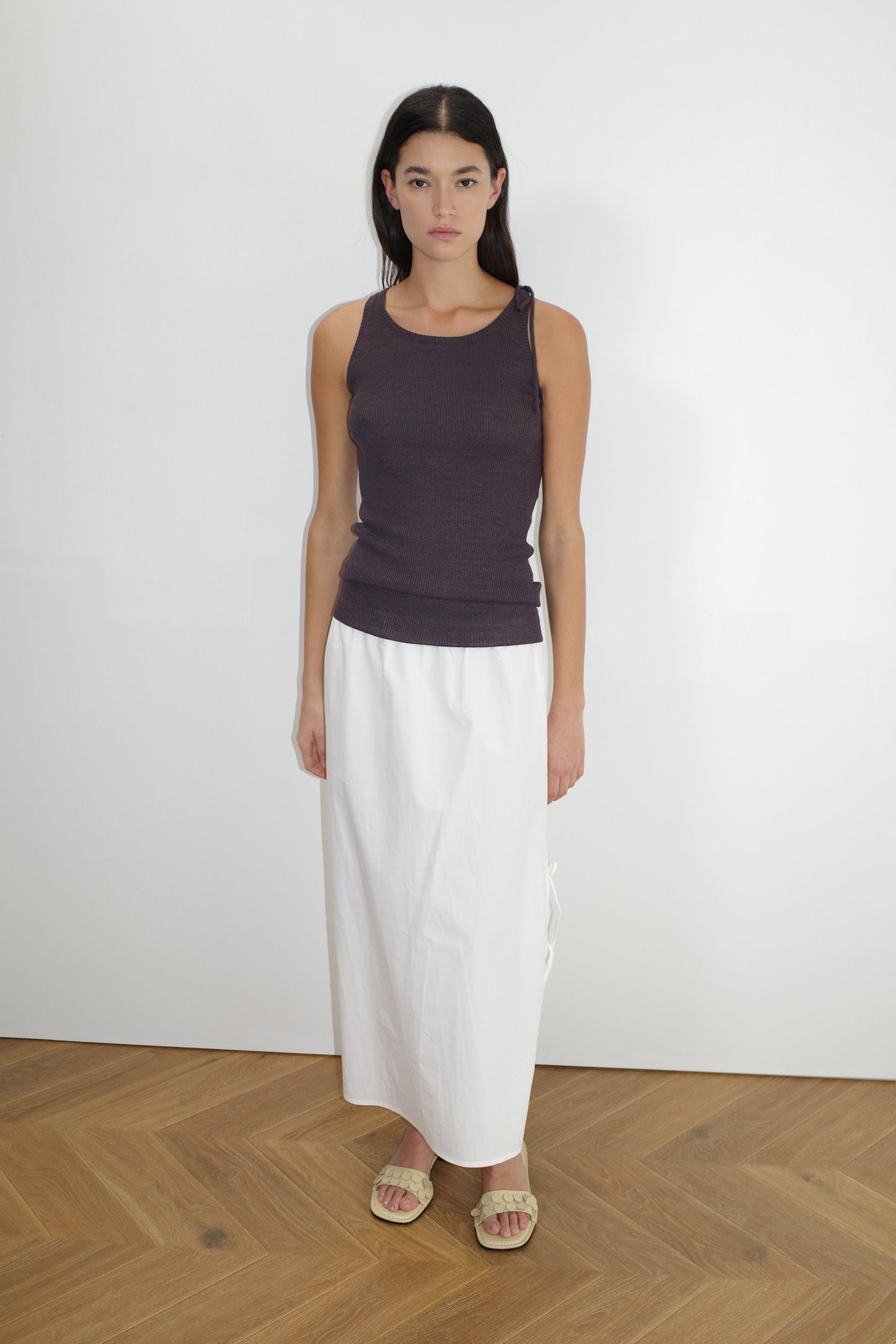 female model wears the split tie skirt by Deiji Studios in white
a mid length, airy skirt designed to sit mid-rise with a soft gathered elastic waist and split side featuring two ties
made from 100% GOTS certified organic cotton poplin
paired with a knit tank in eggplant