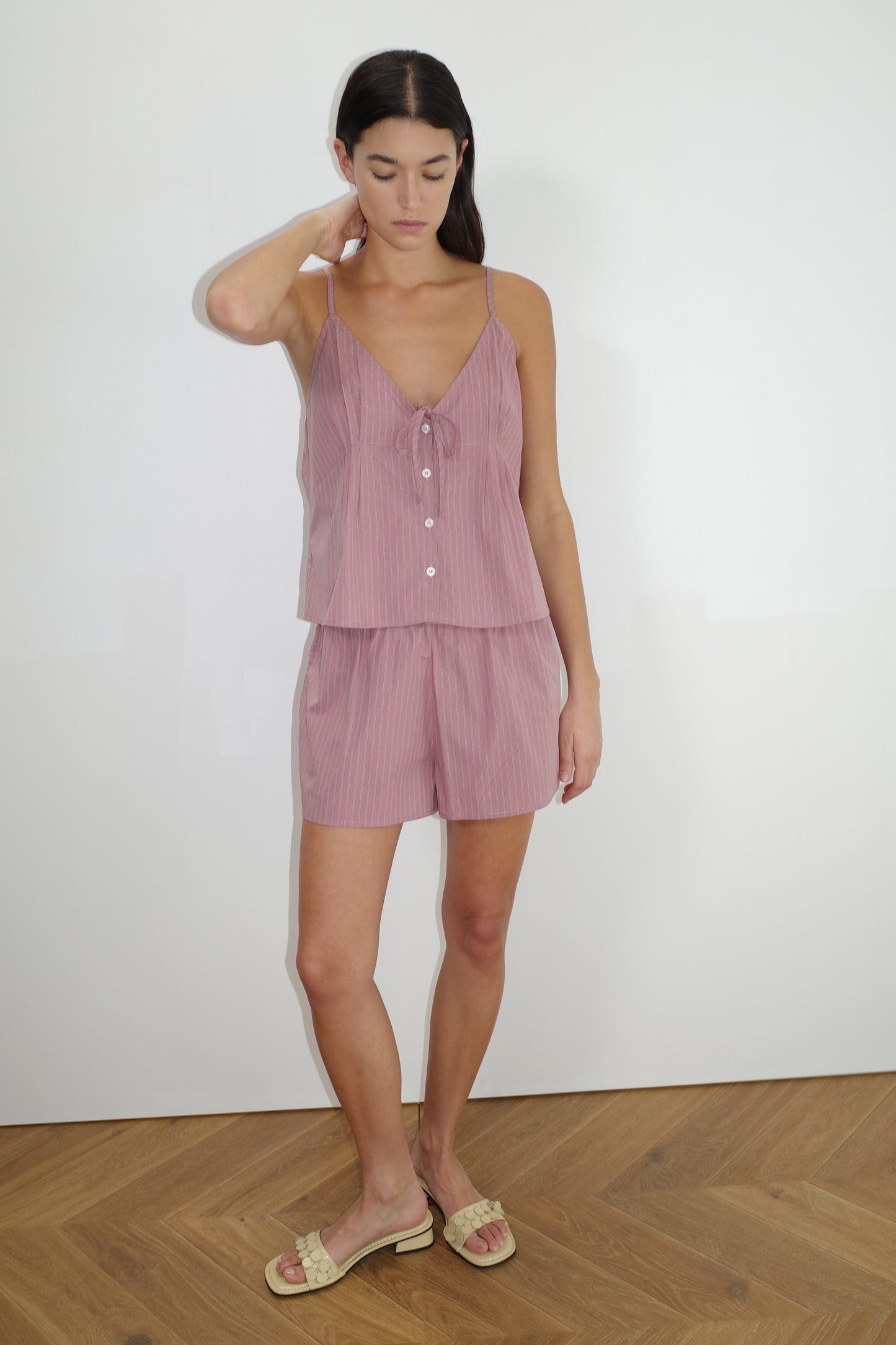 female model wears the placket short set by Deiji Studios in salt stripe
a lightweight everyday top features a flattering v neckline, button down front, side fold pleat detail at bust with a self-fabric tie pairs back with an easy pull on short, featuring a soft elastic waist and side seam pockets to wear as a set or separately
made from 100% organic cotton poplin