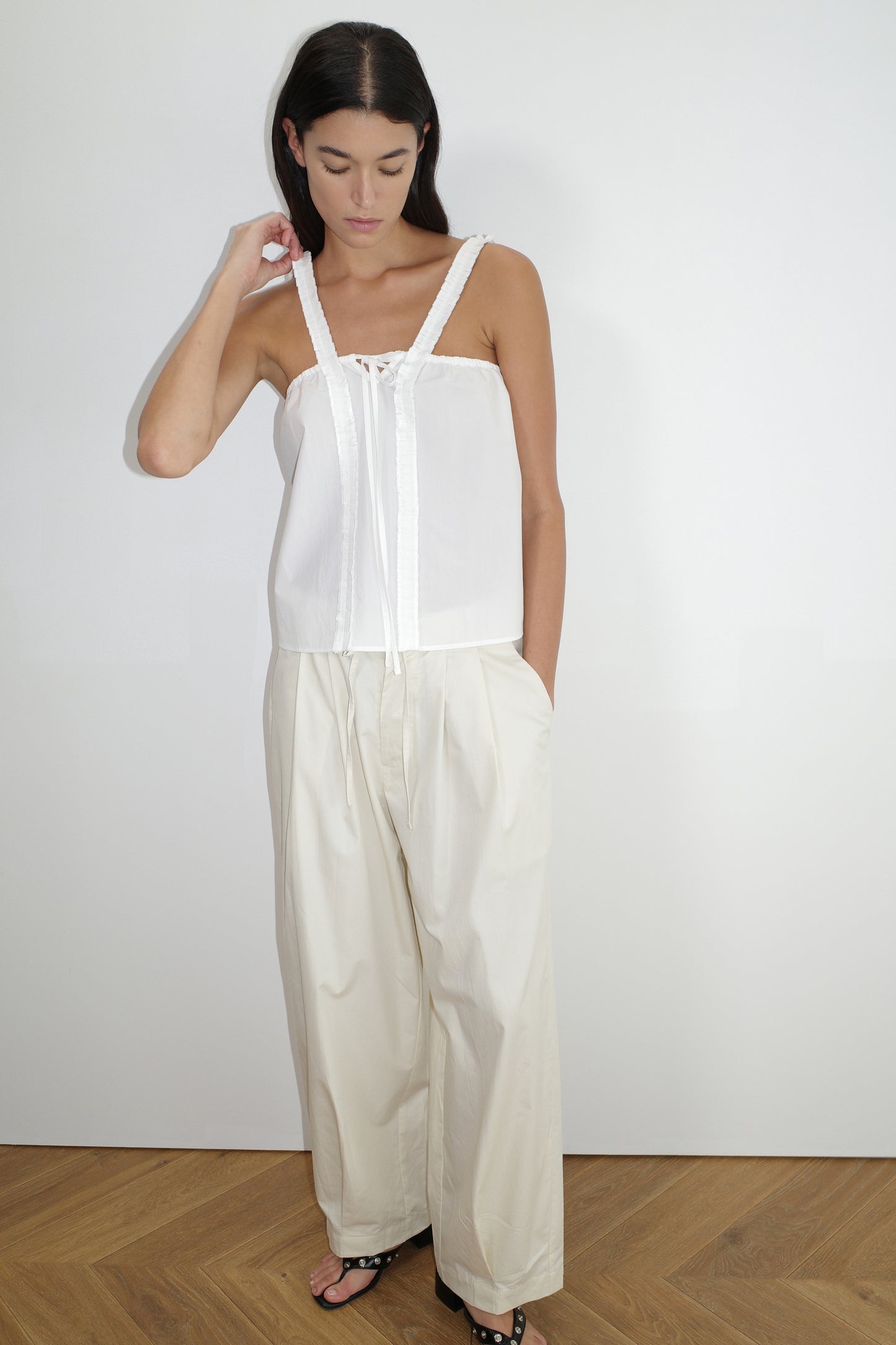 the ruffle strap top by Deiji Studios in white
a relaxed-fit top featuring self-fabric ruffles along the straps and center front, with a tie front detail. designed with elasticated gathering for ease and comfort
made from 100% organic cotton poplin
paired with a off white cotton trouser