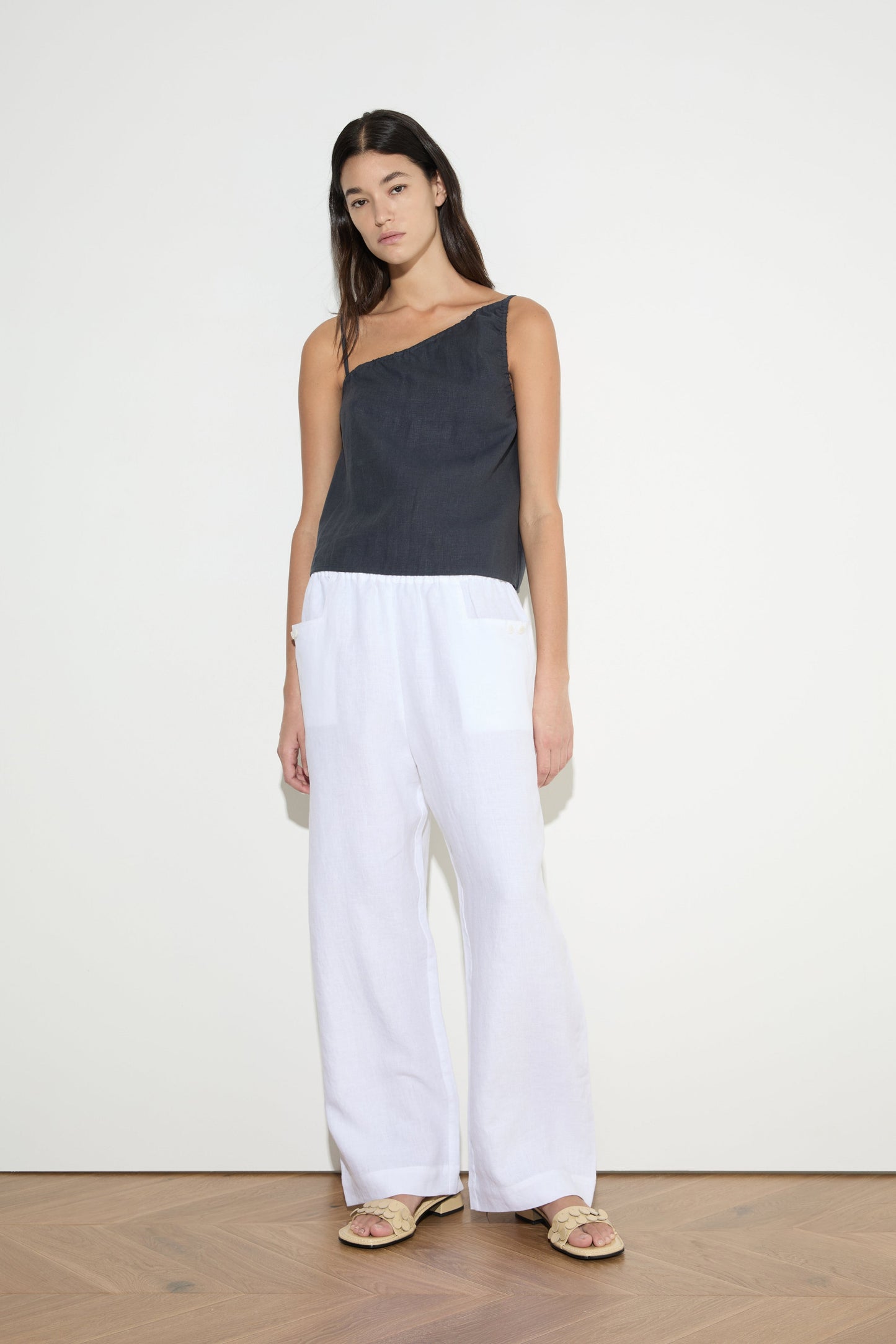 female model wears the asymmetric tie top by Deiji Studios in ink
an elevated asymmetric top with a softly gathered front neckline and elastic neckline
made from 100% GOTS certified organic, OEKO-TEX 100 certified and EU certified stone washed french linen
paired with a white cotton trouser