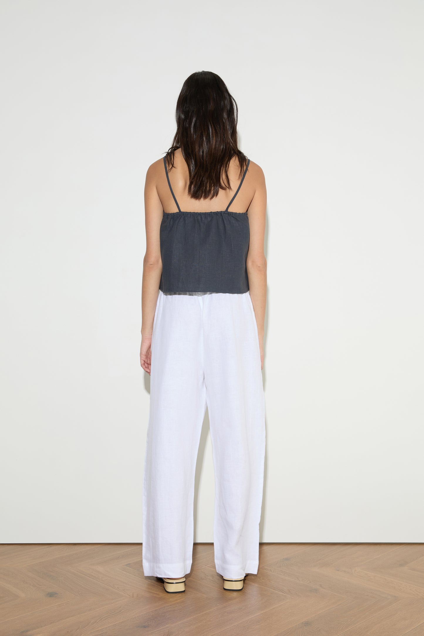female model wears the asymmetric tie top by Deiji Studios in ink
an elevated asymmetric top with a softly gathered front neckline and elastic neckline
made from 100% GOTS certified organic, OEKO-TEX 100 certified and EU certified stone washed french linen
paired with a white cotton trouser