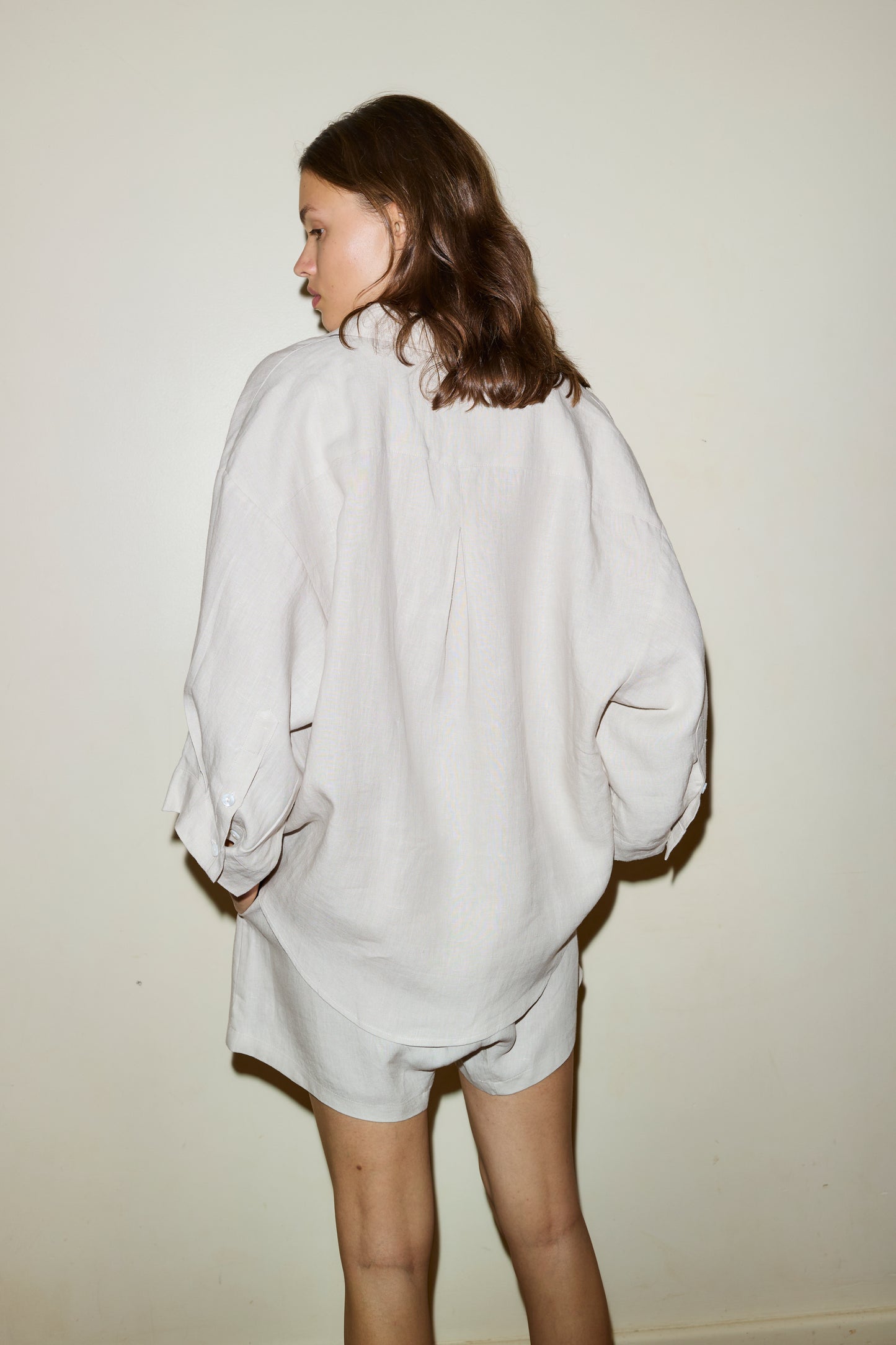 Female model wearing the 03 set - oatmeal by Deiji Studios against plain background