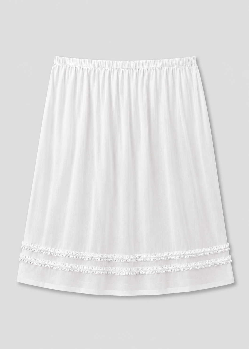 The Daytime Skirt - White is a plain cotton voile midi skirt with an elastic waistband and two rows of decorative lace near the hem, shown on a light gray background.