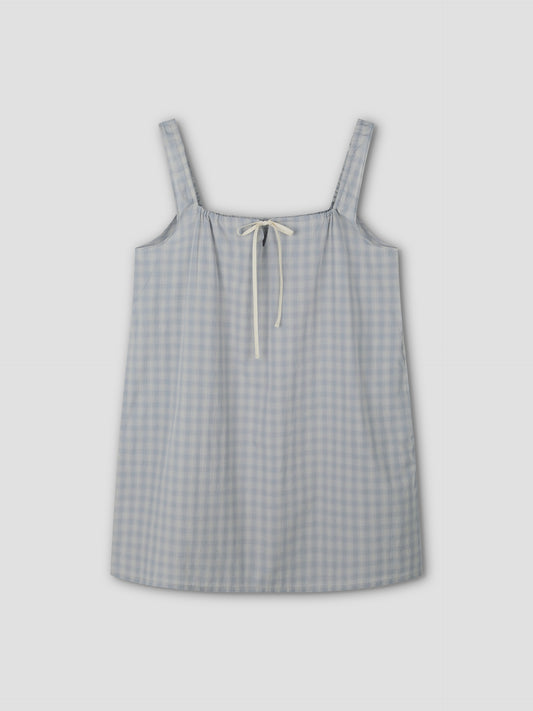 The bow dress - blue check: A sleeveless, mini-length dress with wide shoulder straps and a cream bow tie at the neckline, displayed flat on a light gray background.