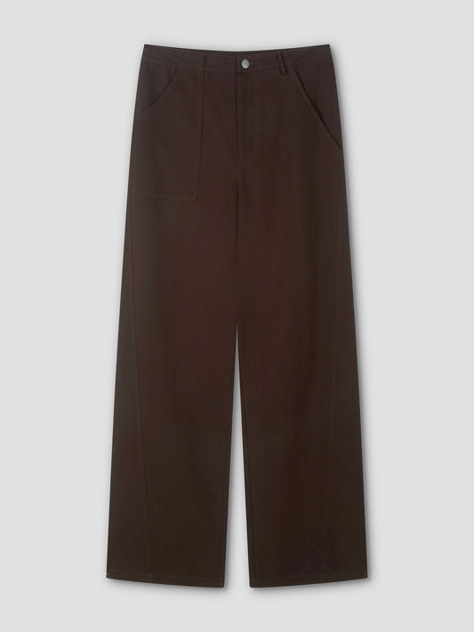 A pair of Pocket Jean wide-leg, dark brown pants with a high waist, front button closure, and side pockets is displayed flat on a light gray background.