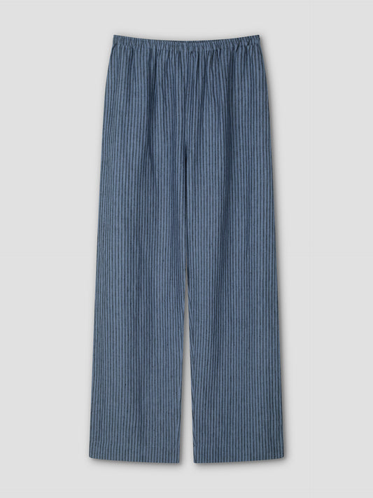 The Linen Ease Trouser - Azure Stripe by Deiji Studios features a loose fit, straight-leg cut, blue fabric with slim vertical azure stripes, and an elastic waistband. Shown against a simple light backdrop.