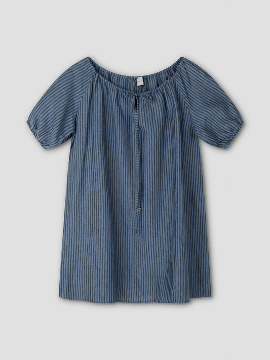 The Smock Dress - Azure Stripe by Deiji Studios is a short-sleeved, loose-fitting mini dress with vertical blue stripes, an elastic off-the-shoulder neckline, a front tie, and lightweight fabric for a casual style.