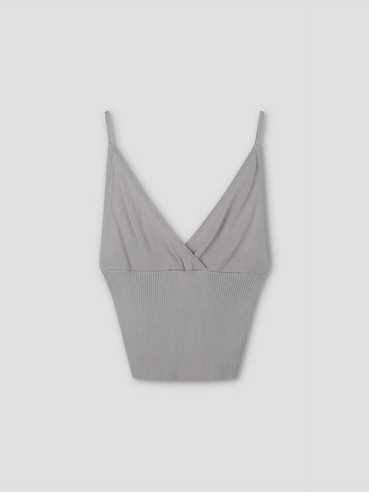 The Cross Panel Knit Top in soft lilac is a cropped tank with thin spaghetti straps, a V-neckline, and ribbed texture on the lower half, inspired by Deiji Studios.