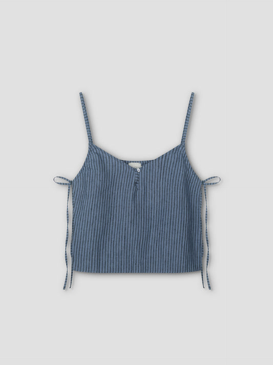 The V Neck Cami - Azure Stripe is a sleeveless crop top with thin shoulder straps, a front button, and side ties. Made from lightweight textured fabric for a relaxed feel, it features an azure stripe pattern on a light grey background.