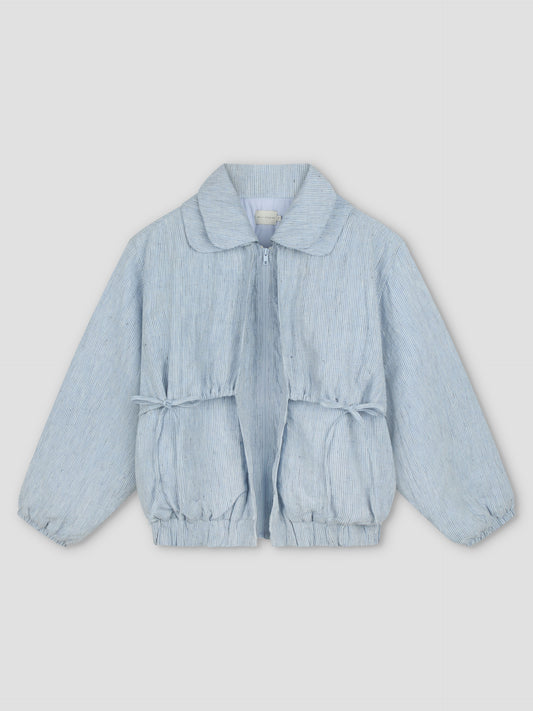 The Double Layered Jacket - Blue Stripe is a light blue bomber-style children's jacket with subtle vertical stripes, front zipper, elasticated cuffs and hem, and gathered waist, shown against a light gray background.