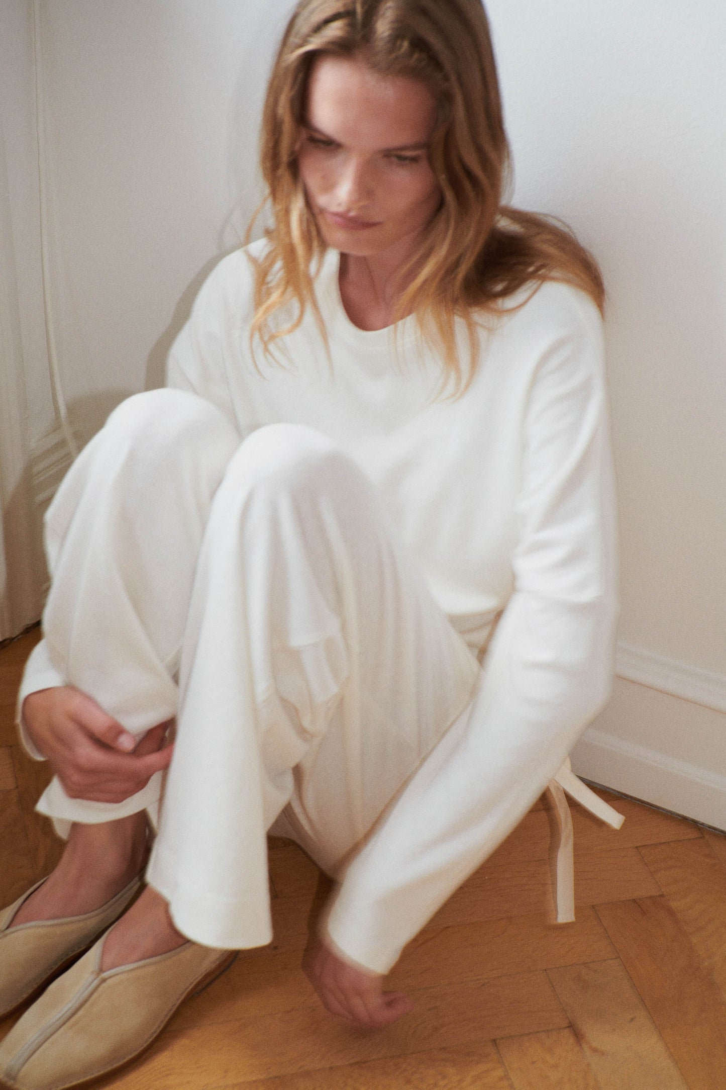 Female model wearing the jersey pant - bone by Deiji Studios against plain background