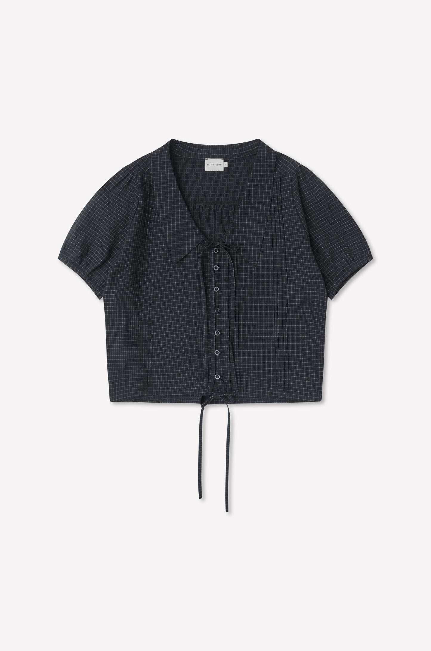 The Fine Collar Top - Mono Grid is a short-sleeved, charcoal gray cotton poplin top with a subtle grid pattern, collared v-neck, and drawstring at the cropped hem, shown laid flat on a white background.