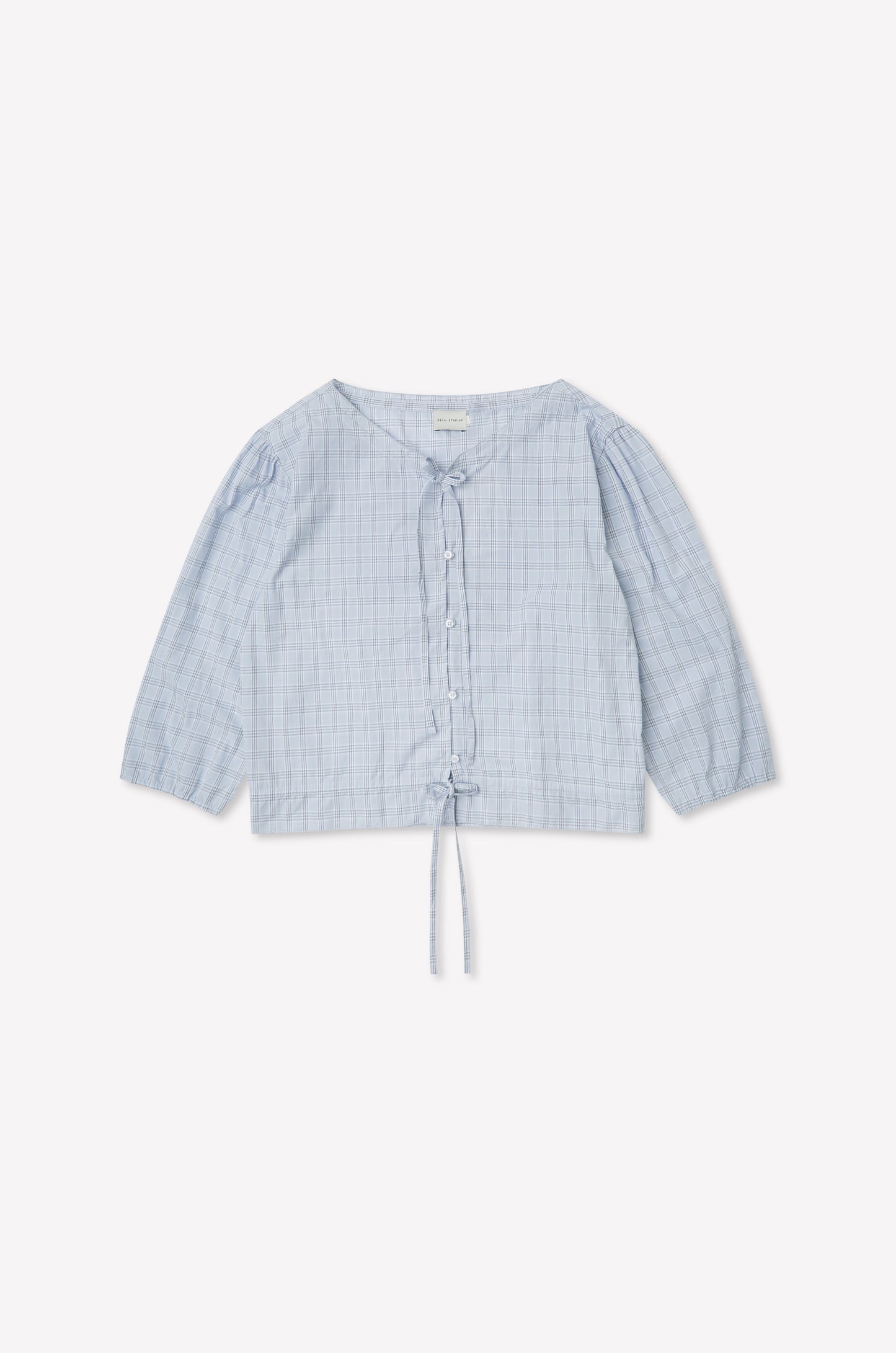 The Corded Top - Powder Check features a light blue, long sleeve design with a subtle check pattern, button-up front, V-neckline, drawstring waist, and slightly puffed sleeves. Inspired by Deiji Studios. Displayed flat on a white background.