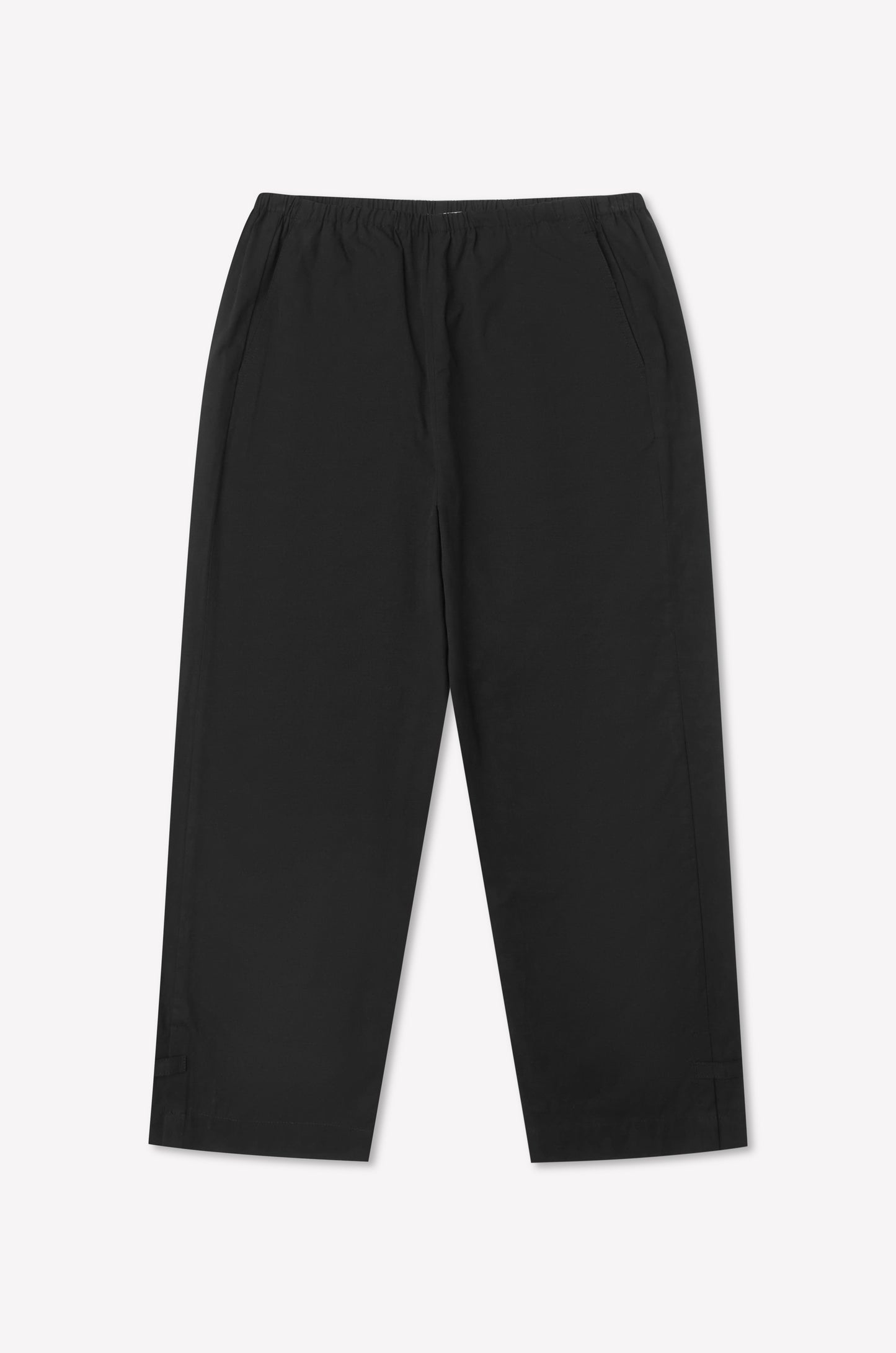 The Capri Pant - Black features a straight-leg silhouette, elastic waistband, and side pockets, laid flat on a white background—a versatile take on the relaxed cropped style inspired by Deiji Studios.