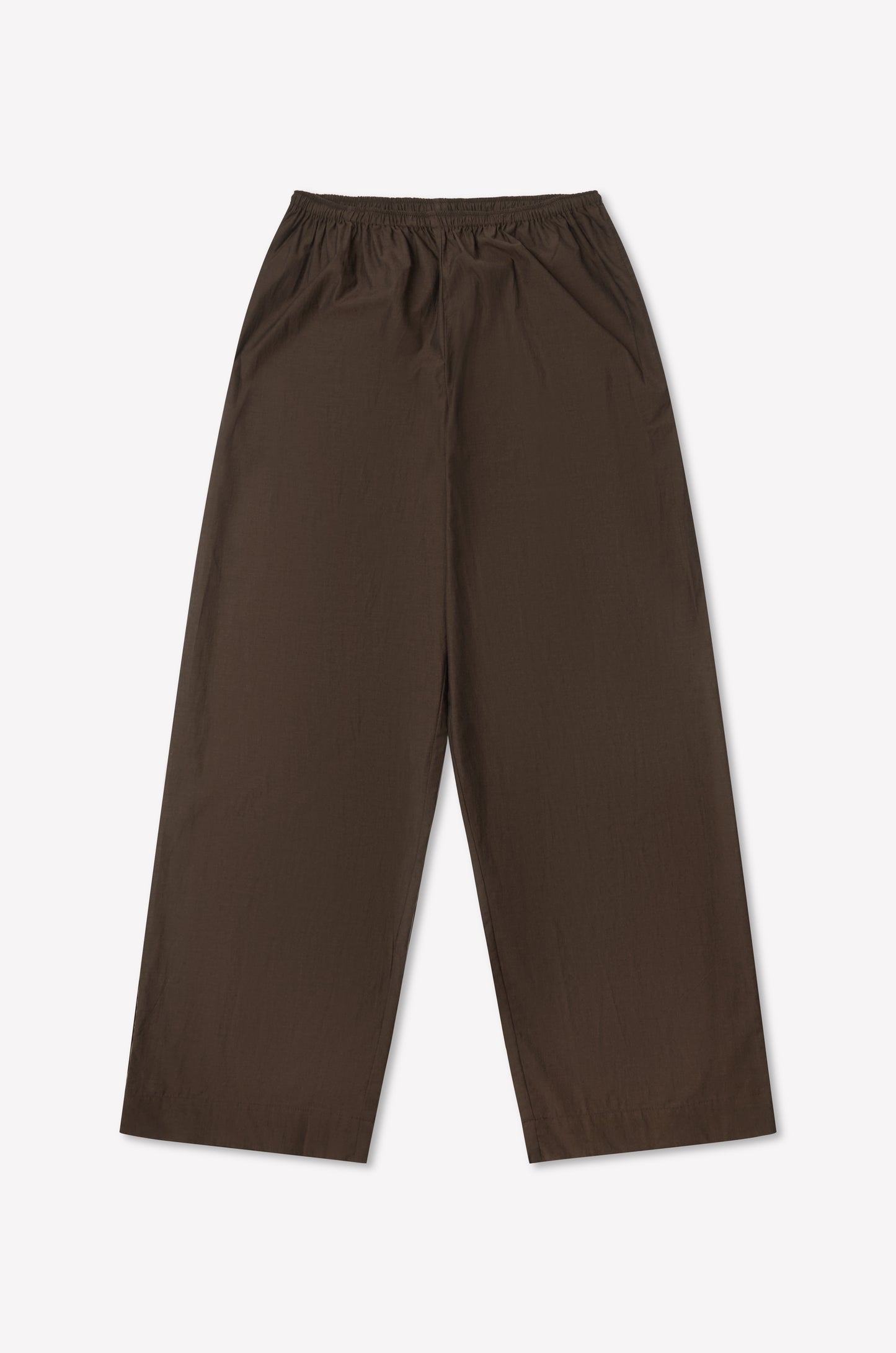 The Ease Trouser - Toast is a wide-leg brown pant with an elastic waistband, ankle length, and minimalist design. Laid flat on a plain white background, it features no visible pockets or extra details.