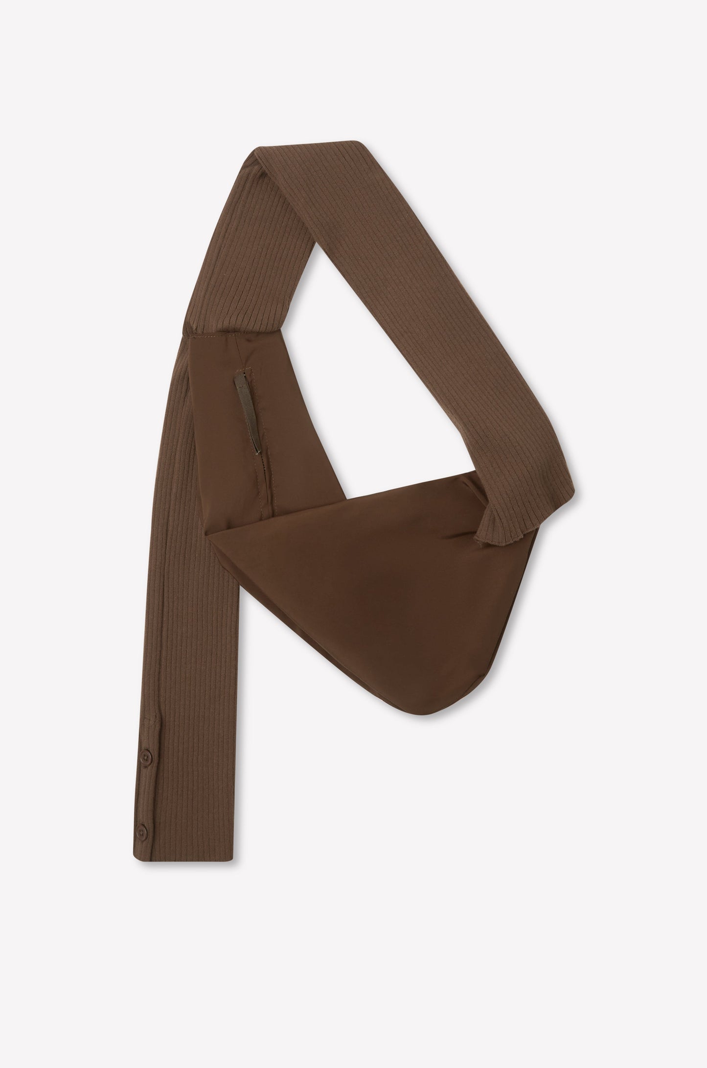 The Knit Strap Bag - Hazel is a brown, asymmetrical bag with a wide ribbed knit strap, zippered pocket, and button details on one end, displayed flat on a white background.
