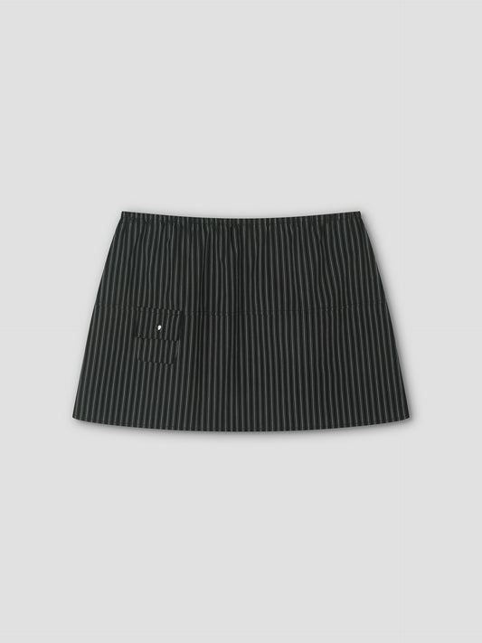 The Pocket Skirt - Mono Stripe is a black mini skirt with thin white pinstripes, an elastic waistband, and a small left front pocket, shown against a plain light gray background.