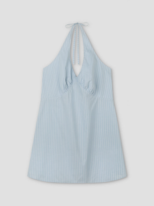 Cinched Halter Dress - Lake Blue Stripe from Deiji Studios, featuring light blue fabric with subtle vertical white stripes, a sleeveless design, gathered chest, and halter neck tie, shown laid flat on a white background.