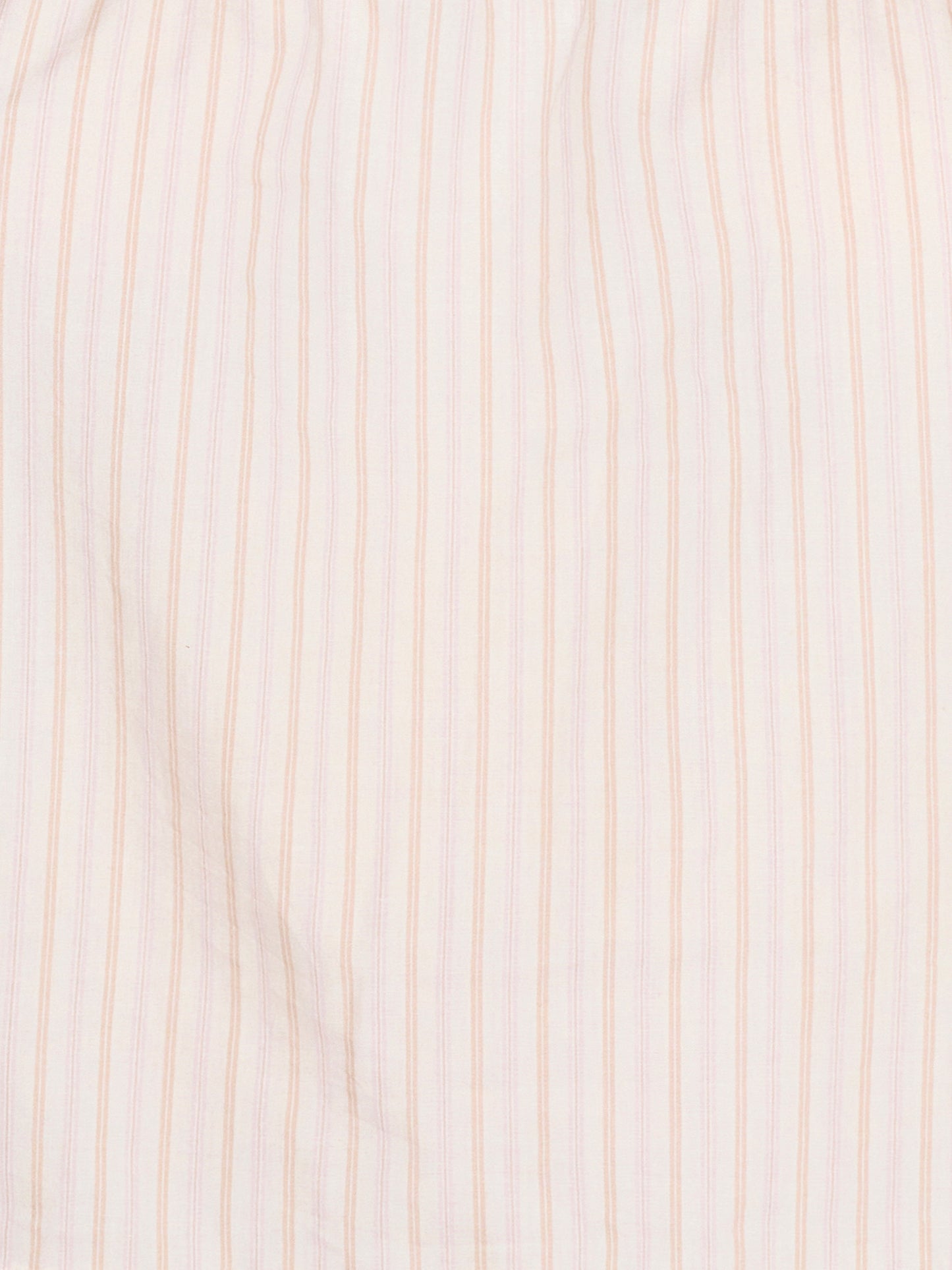 A close-up of the Room Shirt - Dusty Stripe by Deiji Studios shows its organic cotton fabric with evenly spaced thin vertical pink stripes on a white background.