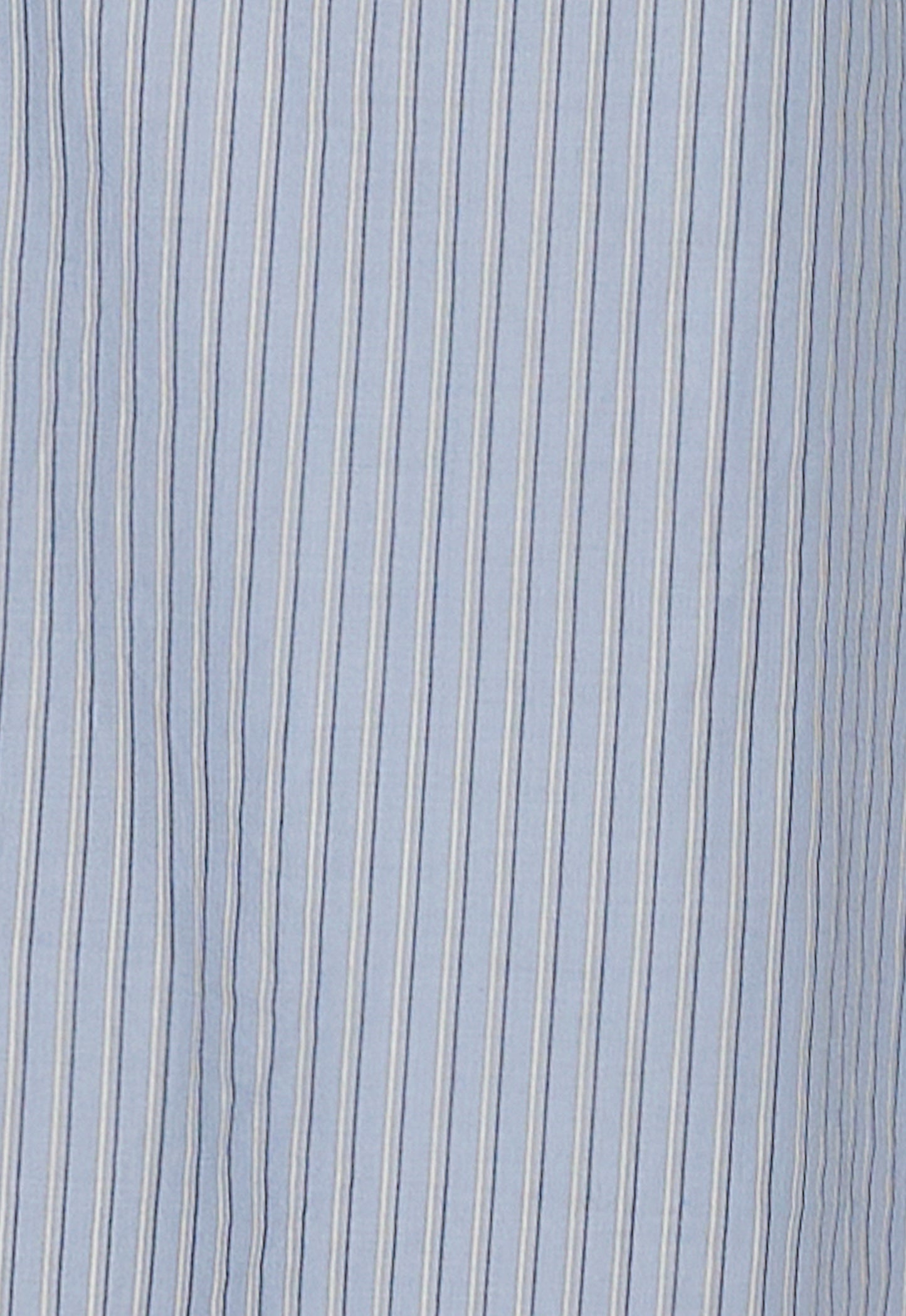 Close-up of the Ease Trouser - Glacier Stripe: light blue with thin vertical white and dark blue pinstripes, crafted from organic cotton by Deiji Studios.