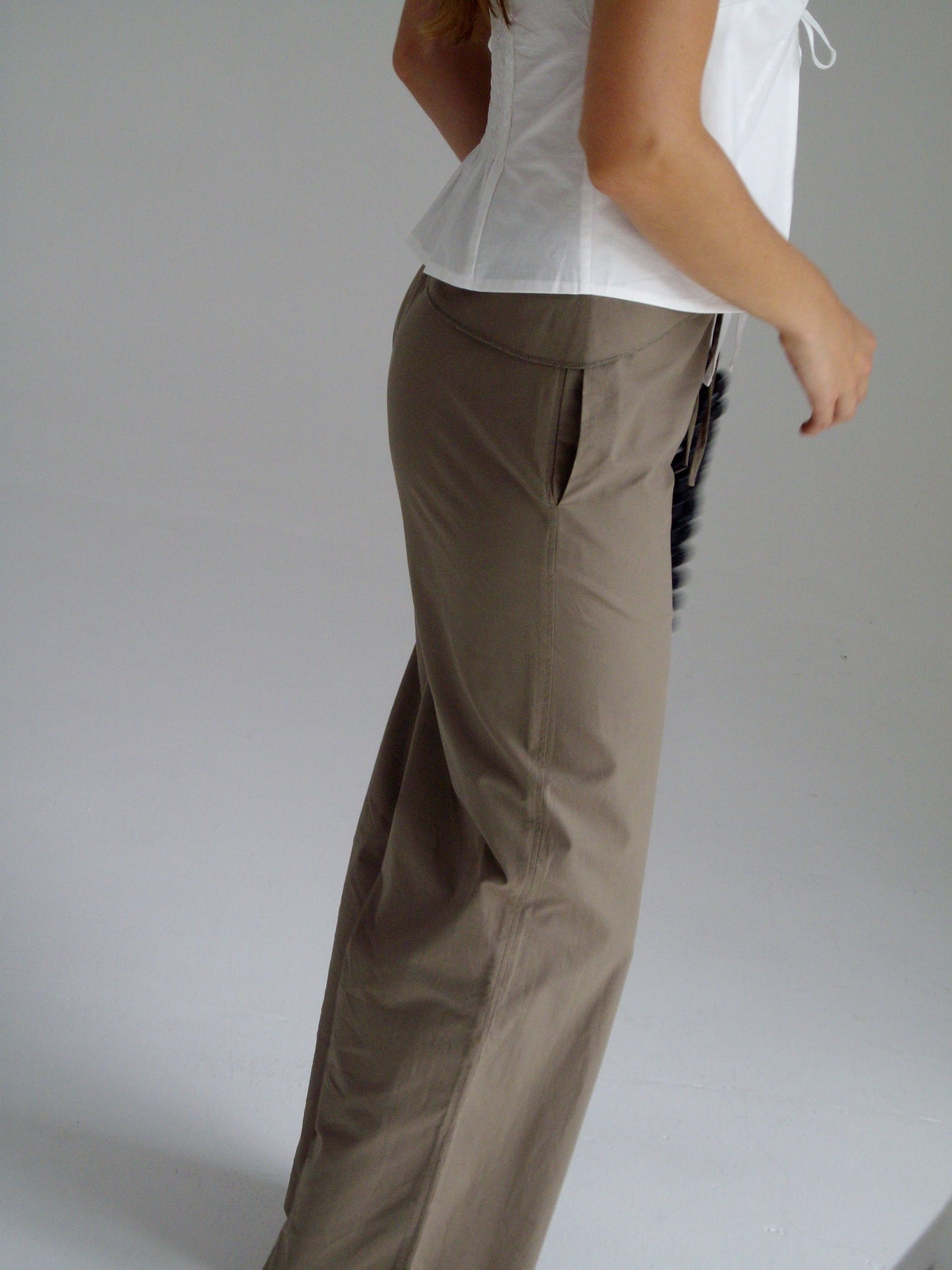 female model wears the belted pant by Deiji Studios in clay
mid-rise loose-leg pant with attached tie-front belt detail, babylock hem, and relaxed fit. features concealed zip closure and side pockets
made from 100% organic cotton
paired with a white cotton top