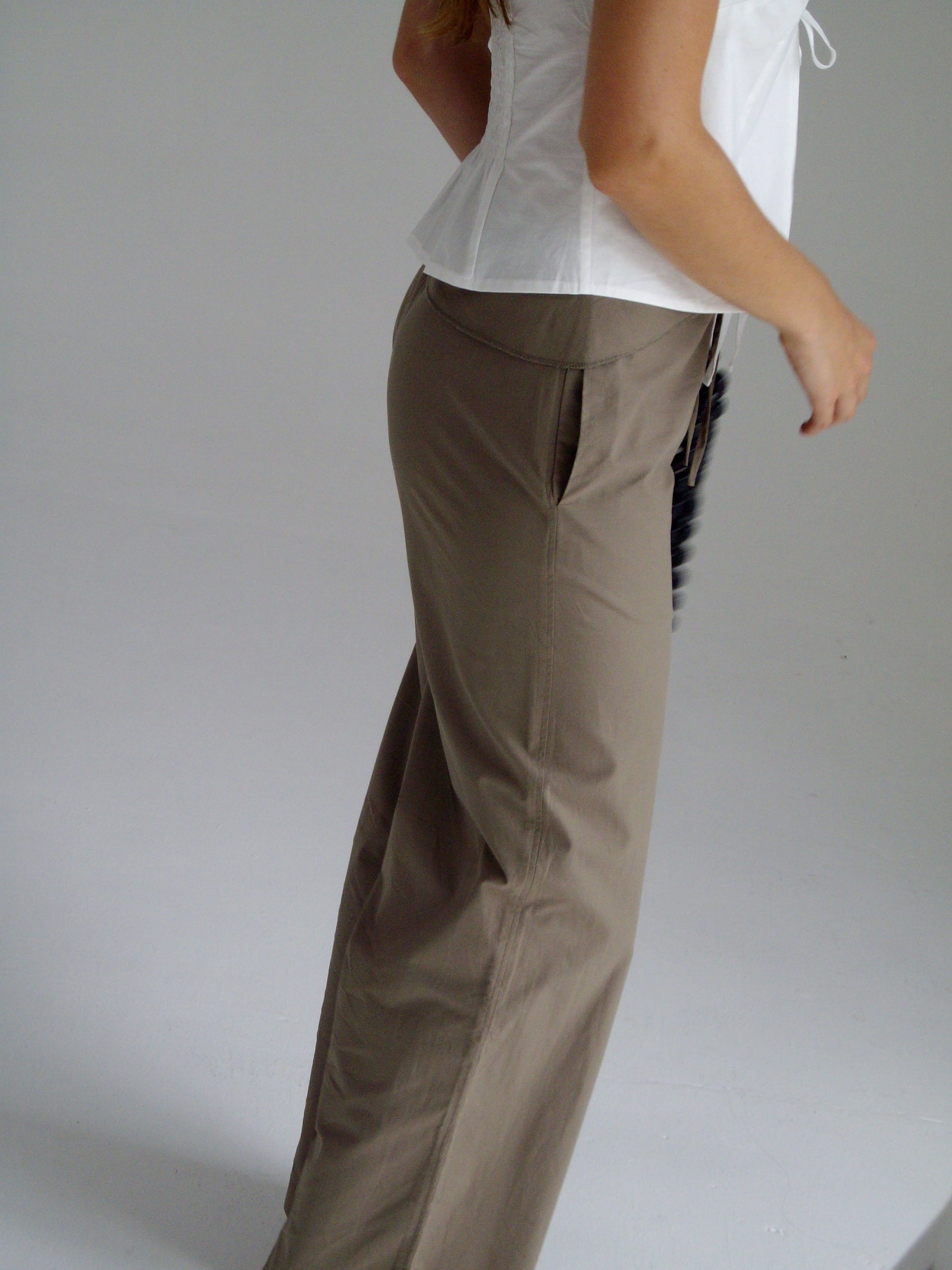 female model wears the belted pant by Deiji Studios in clay
mid-rise loose-leg pant with attached tie-front belt detail, babylock hem, and relaxed fit. features concealed zip closure and side pockets
made from 100% organic cotton
paired with a white cotton top