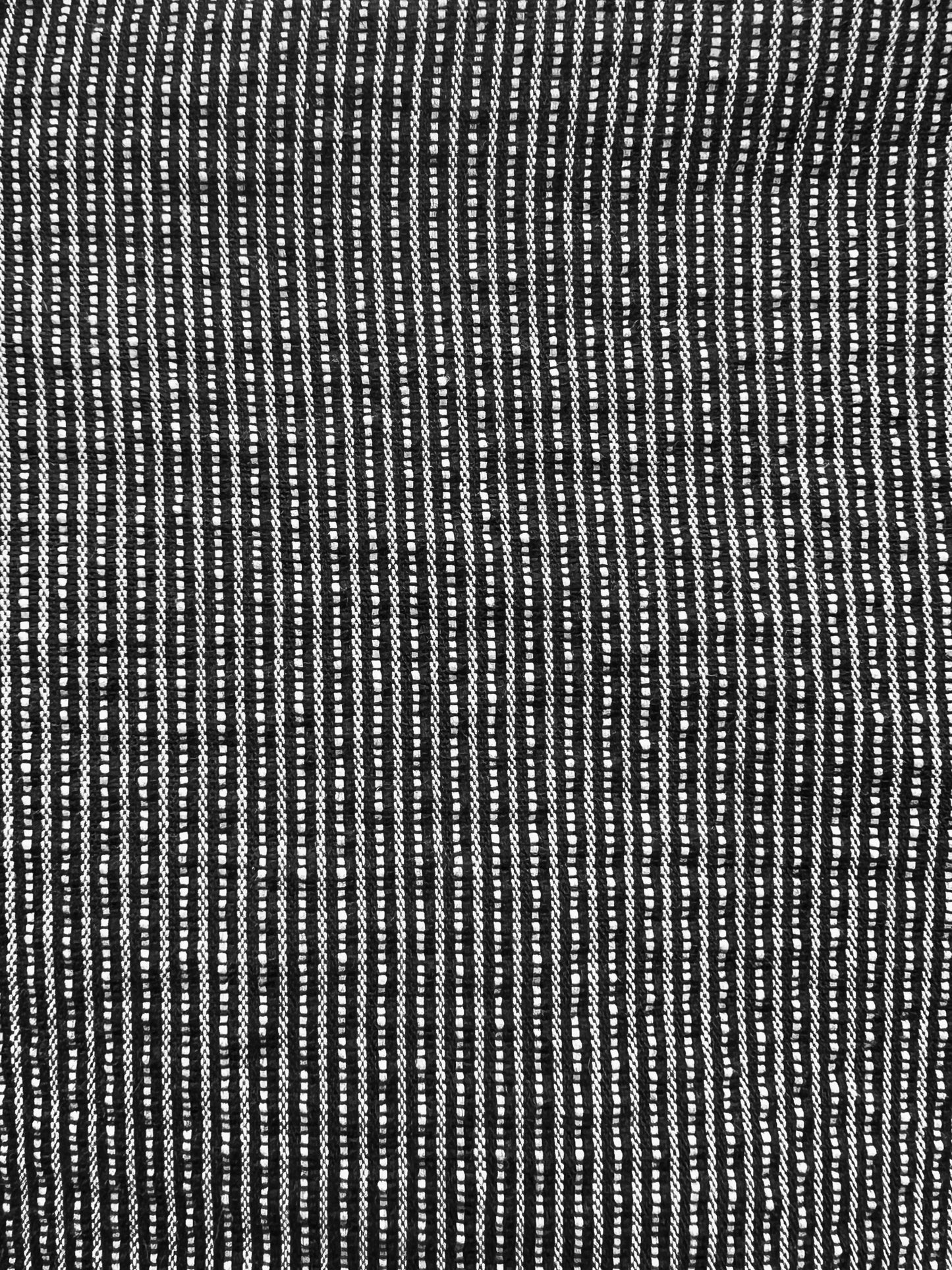 Close-up of the Exclusive Bubble Coat - Black White Stripe by 0, featuring textured black and white stripes formed by uneven dashes for a woven look—ideal for organic cotton outerwear.