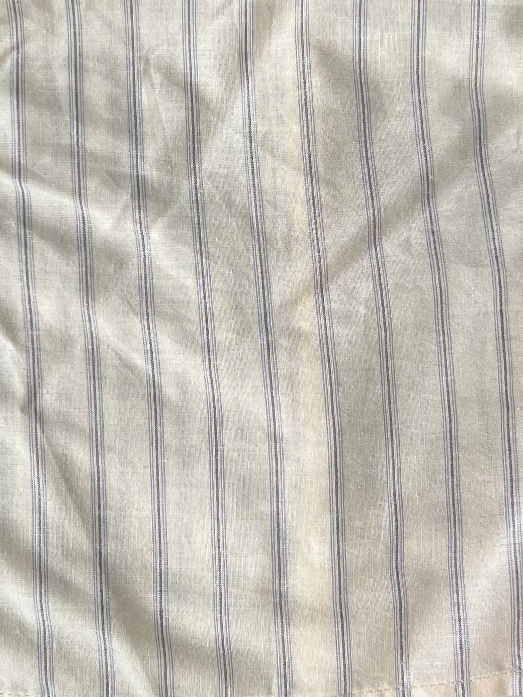 female model wears the gathered shirt by Deiji Studios in raquette stripe
a classic button up style shirt featuring a butter base with mixed blue stripe, elasticated gathered seams and dropped shoulder for a relaxed fit
made from 100% GOTS organic cotton
paired with a black pant