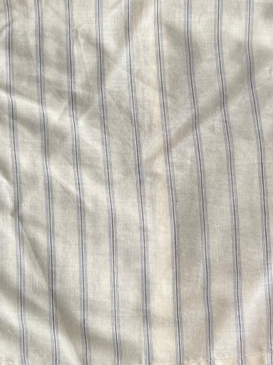 female model wears the gathered shirt by Deiji Studios in raquette stripe
a classic button up style shirt featuring a butter base with mixed blue stripe, elasticated gathered seams and dropped shoulder for a relaxed fit
made from 100% GOTS organic cotton
paired with a black pant
