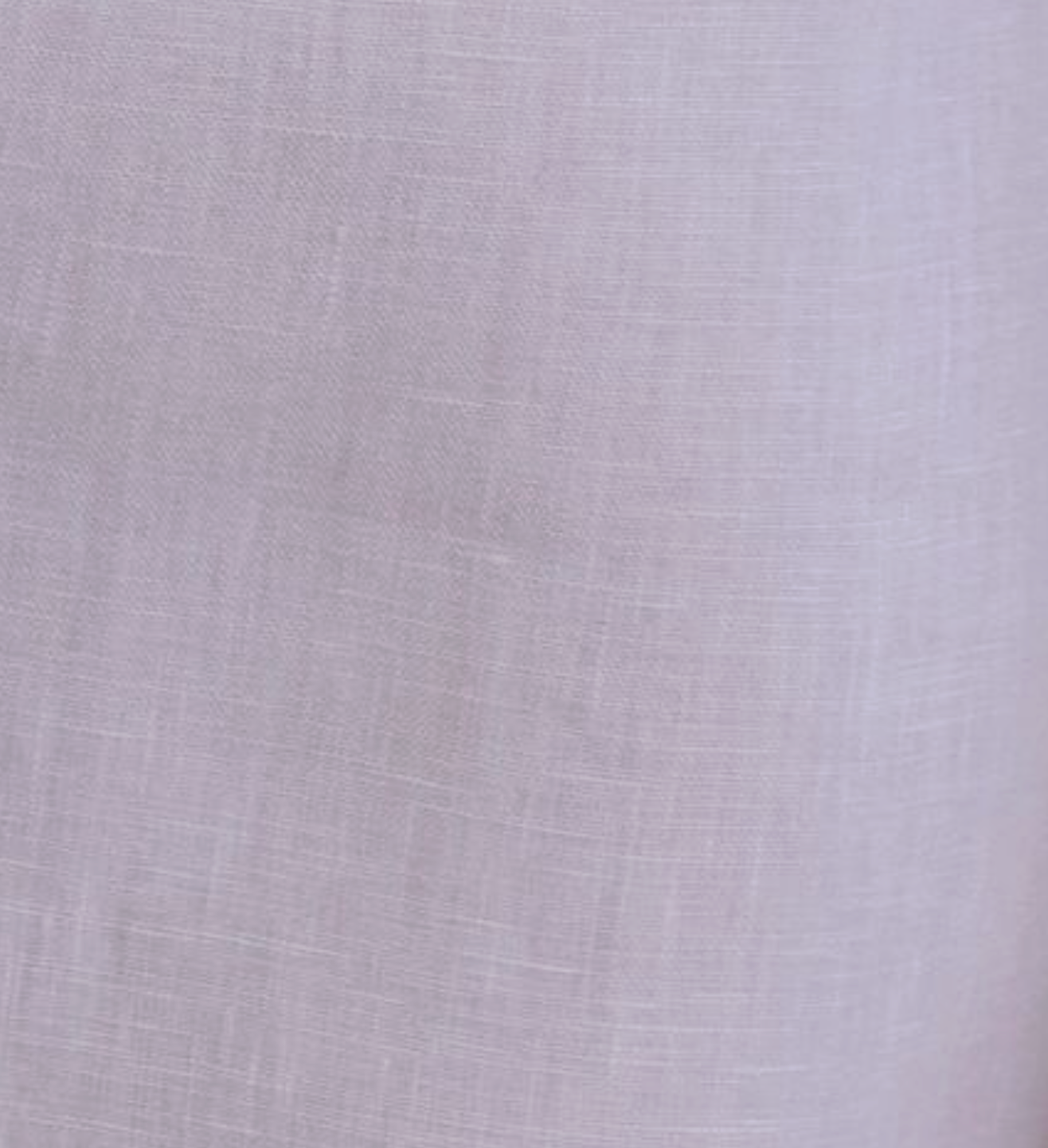 Close-up of the Linen Ease Trouser in lilac, crafted from organic French linen with a subtle weave texture and a soft, slightly translucent finish.
