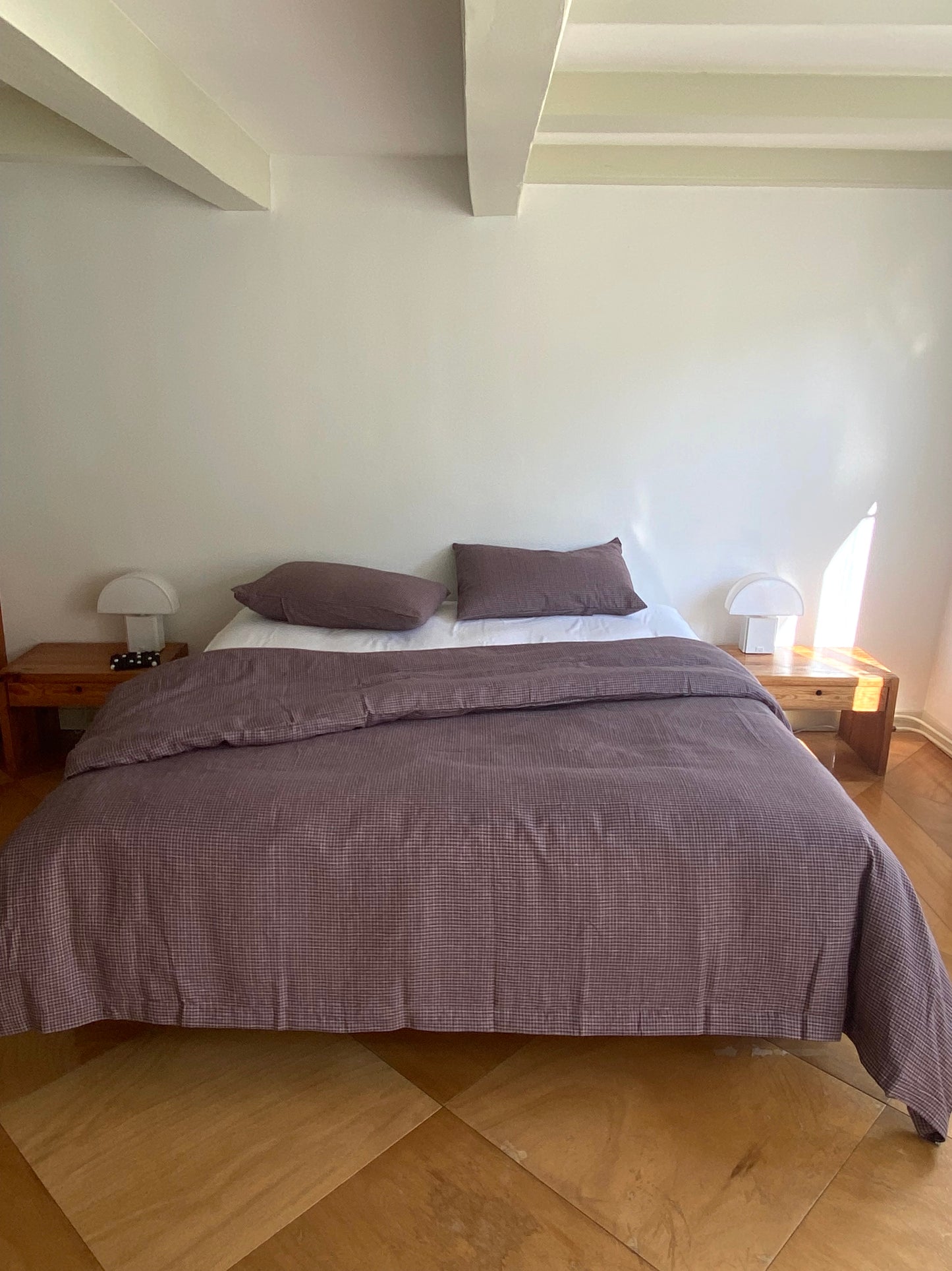Light room with queen bed topped with Duvet cover - russet check by Deiji Studios