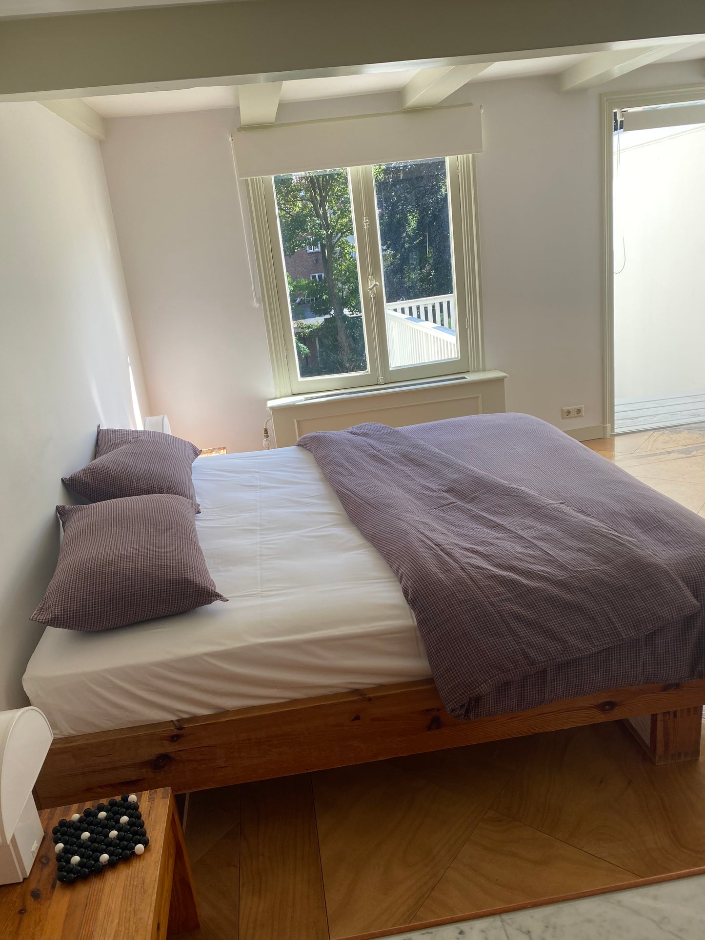 Light room with queen bed topped with Duvet cover - russet check by Deiji Studios
