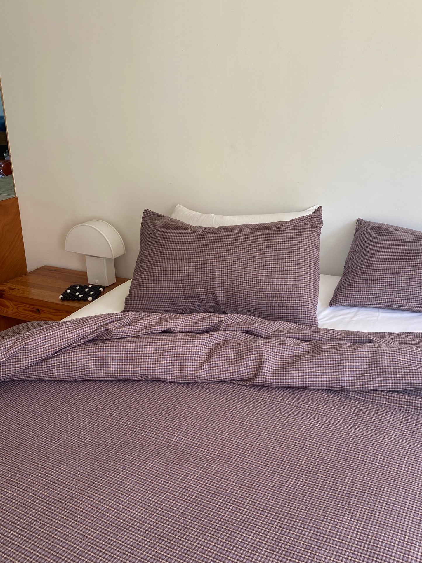 Light room with queen bed topped with Duvet cover - russet check by Deiji Studios