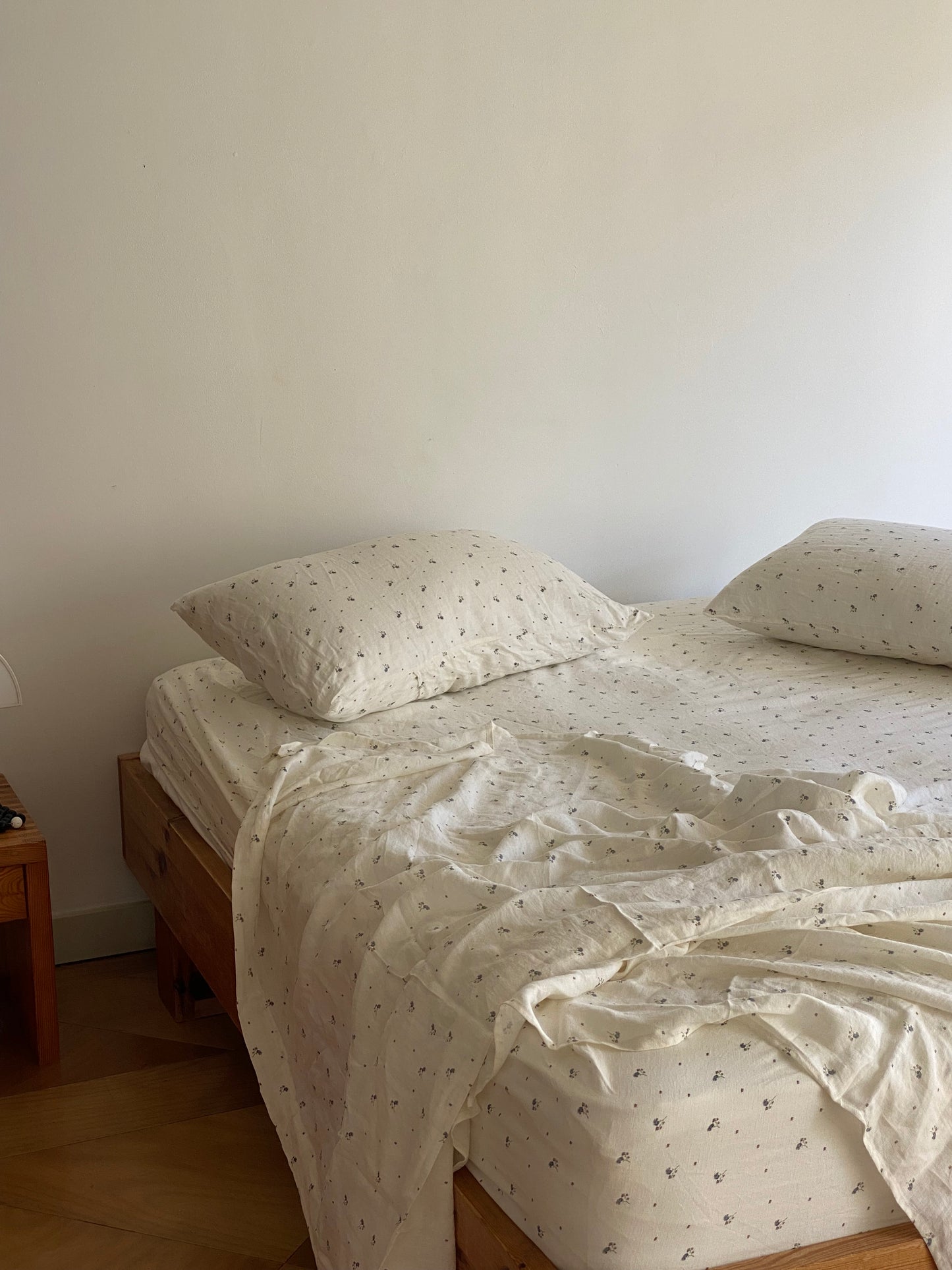 Light room with queen bed topped with Sheets - vintage floral by Deiji Studios