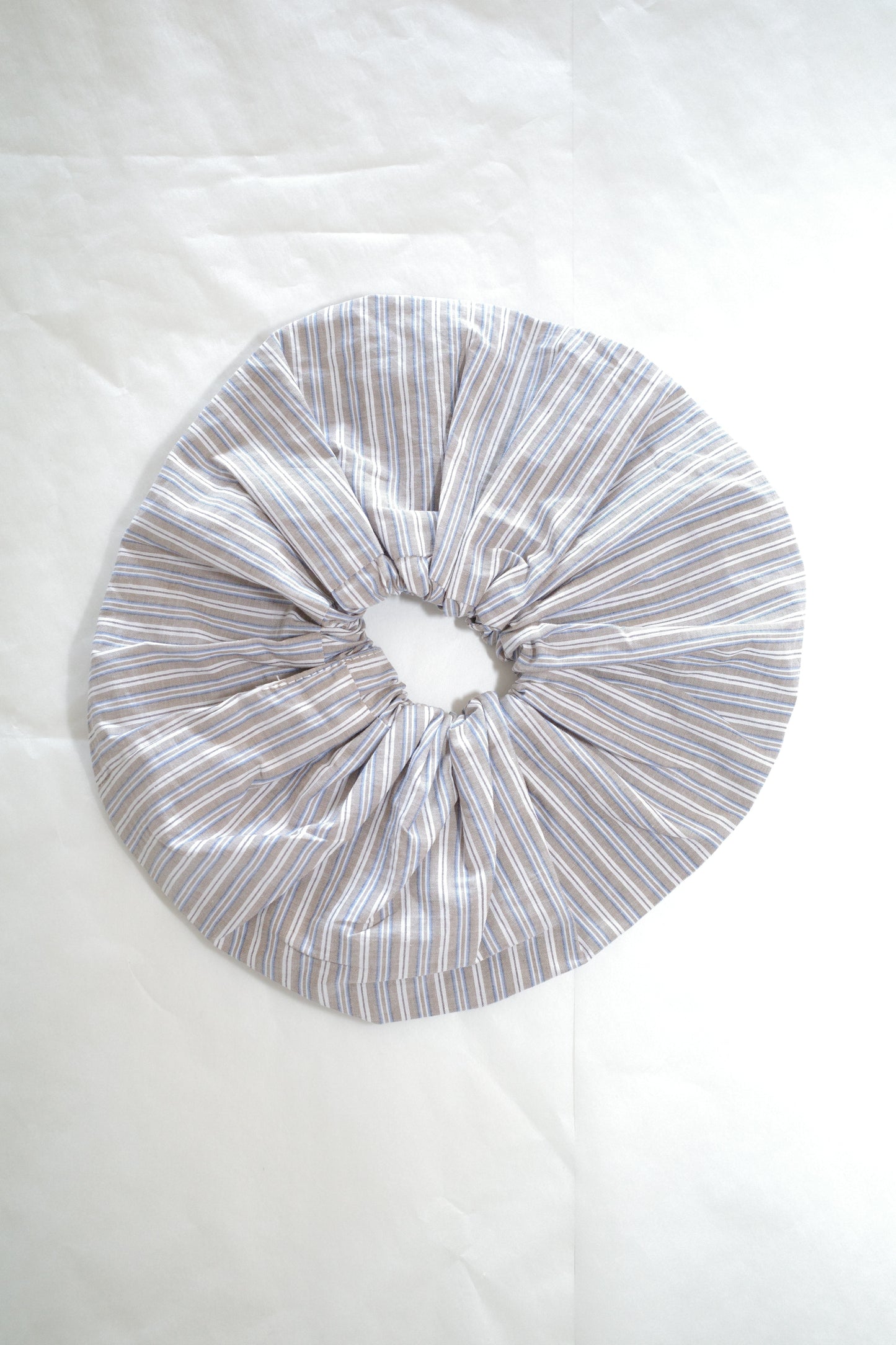 flat-lay image of the scrunchie by Deiji Studios in seas stripe
an oversized cotton elasticated scrunchie to be worn in hair or on wrist.
made from 100% organic cotton
