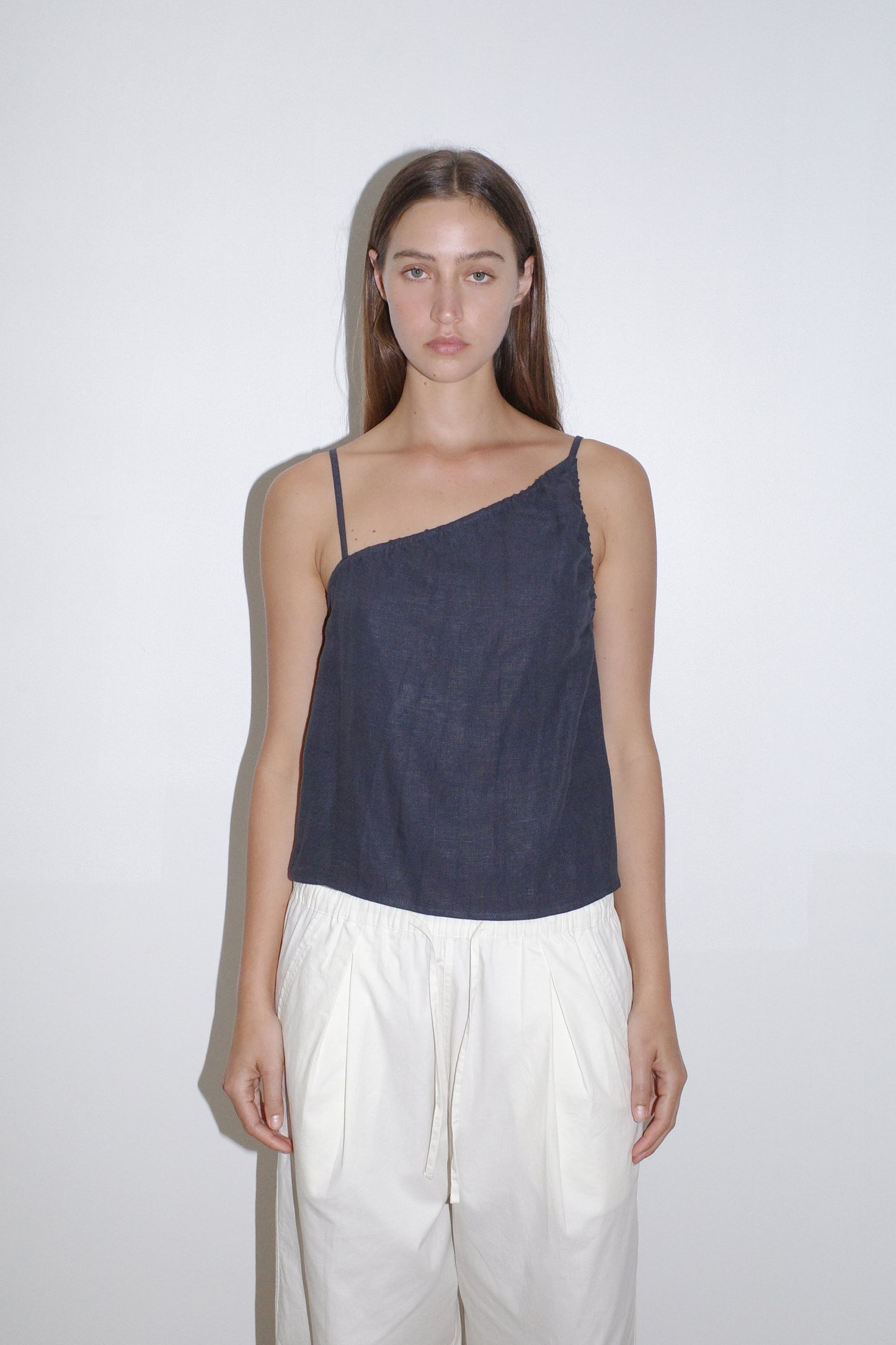 female model wears the asymmetric tie top by Deiji Studios in ink
an elevated asymmetric top with a softly gathered front neckline and elastic neckline
made from 100% GOTS certified organic, OEKO-TEX 100 certified and EU certified stone washed french linen
paired with a white cotton trouser