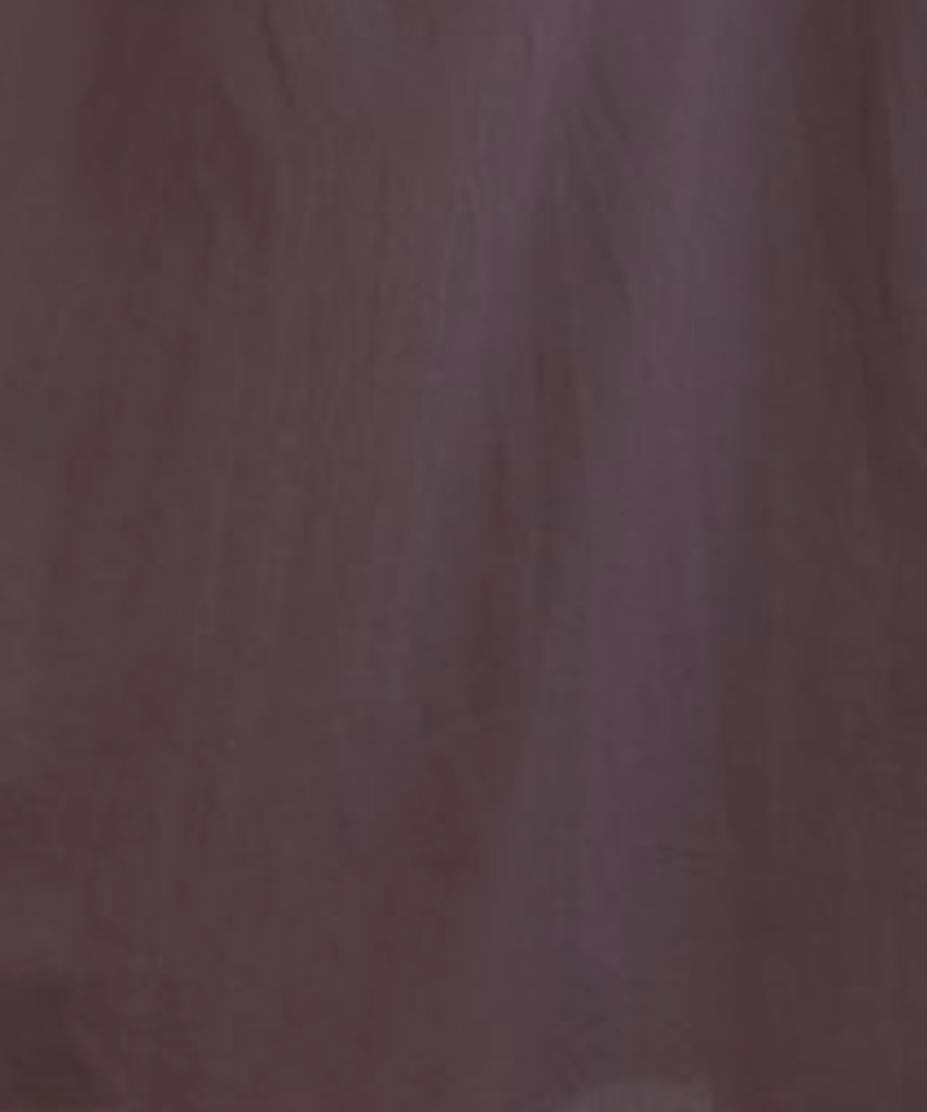 A close-up of the delicate, sheer texture and slight translucency of the Pintuck Dress - Raisin, reflecting the refined finish characteristic of this Deiji Studios organic cotton piece.