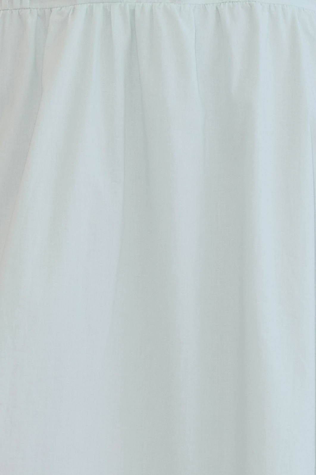 The Simple Skirt - Mint by Deiji Studios is crafted from light blue organic cotton with a gathered top seam, creating gentle folds and a soft texture for an elegant, minimalist look.