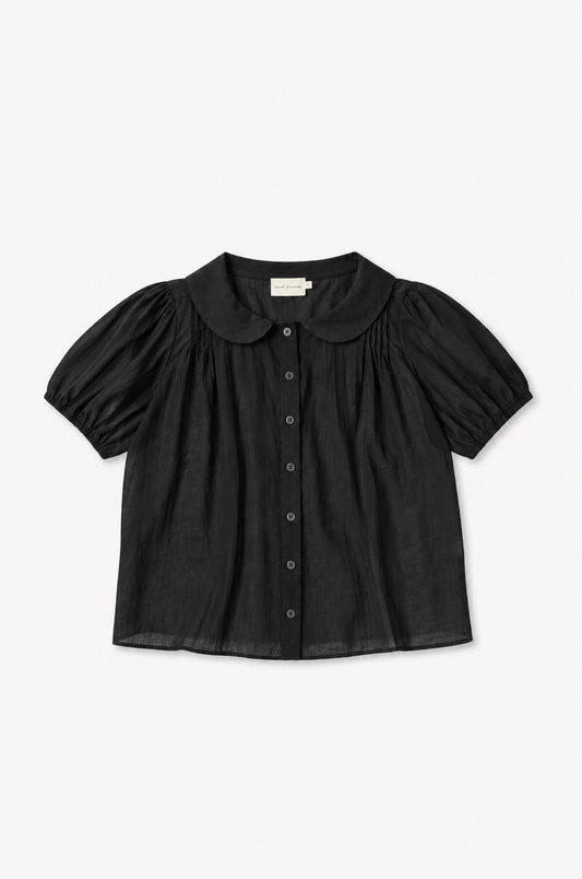 The Petal Top - Black by Deiji Studios laid flat against a plain white background, a lightweight cotton voile top with a rounded peter pan collar, button-through front and gently puffed short sleeves.